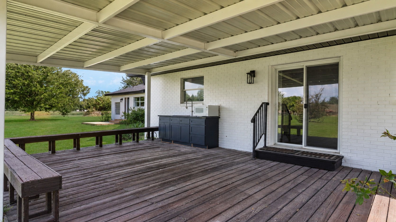 Over sized Covered porch with cabinets, hot and cold water, large deep farm sink