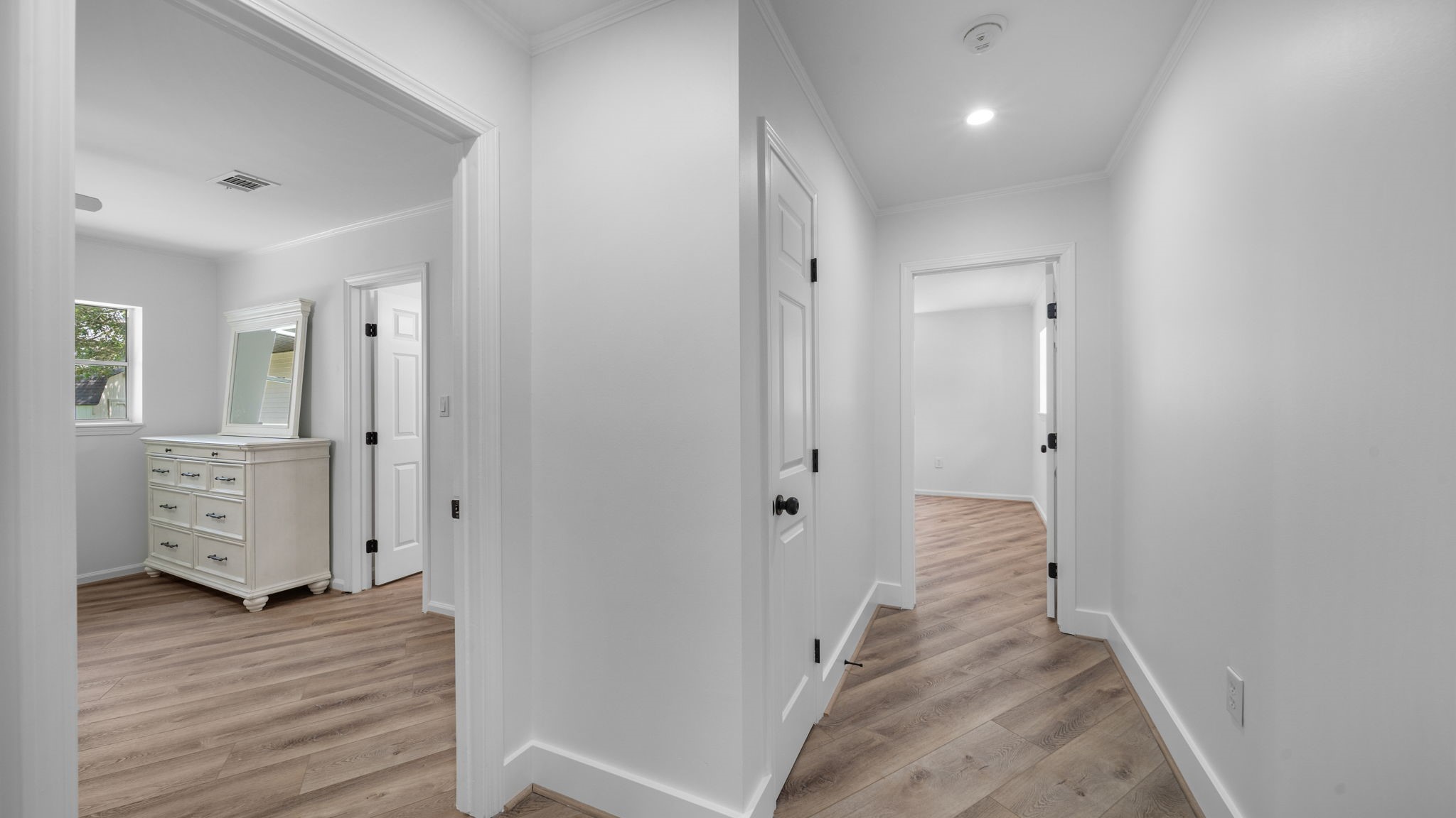 Secondary bedroom wing hallway, and linen closet, behind barn door