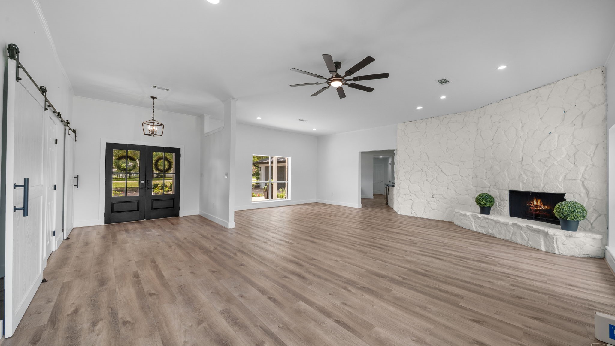 Entry, dining and Family Room. This is a very large open space, If an office is needed, the custom plans do show where an office can go. Just ask to view. Barn doors take you into the hallway to 2 bedrooms, other one takes you into hall of the Primary Retreat