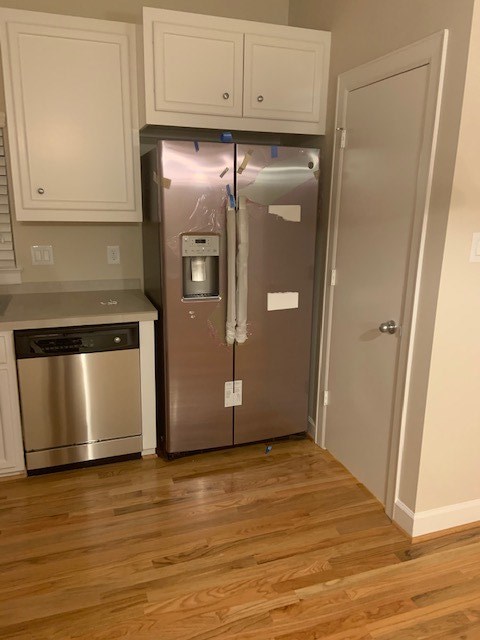 Stainless steel refrigerator in kitchen.