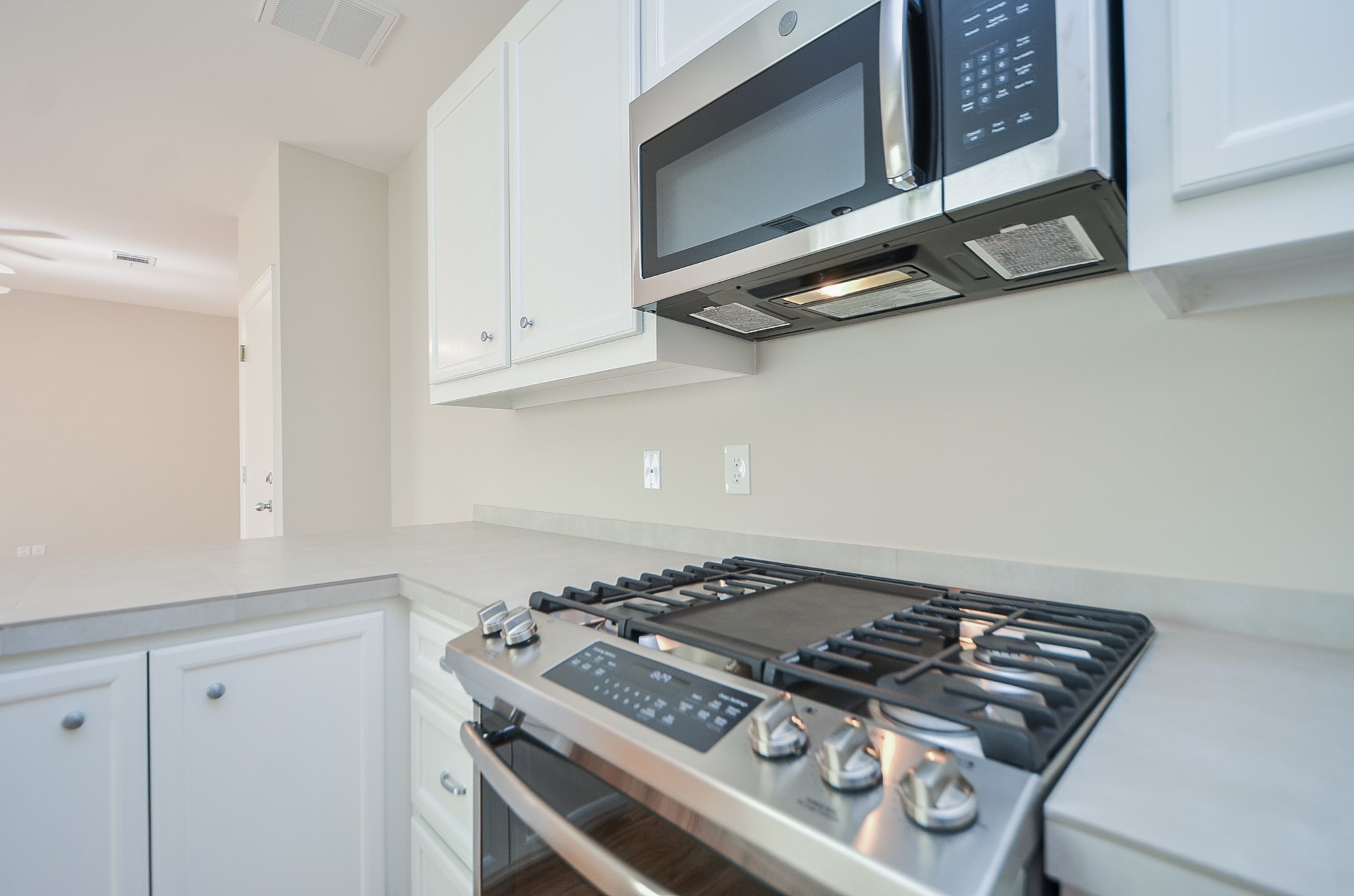 Property comes with five burner,  GE gas stove with a griddle, convention oven, stainless steel microwave, and fridge.