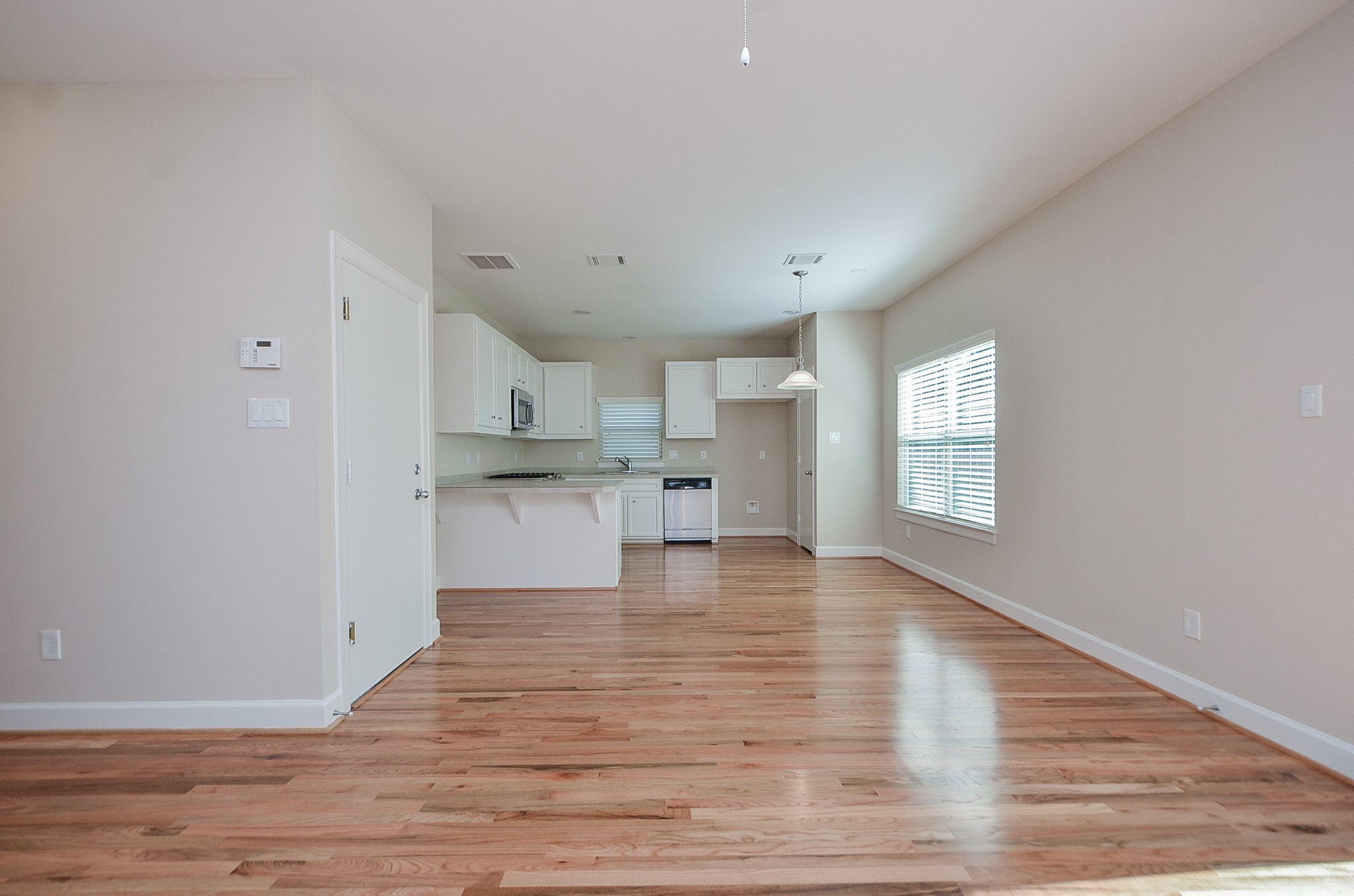 An additional view from the living area into the kitchen.  The door to the left leads into the garage.