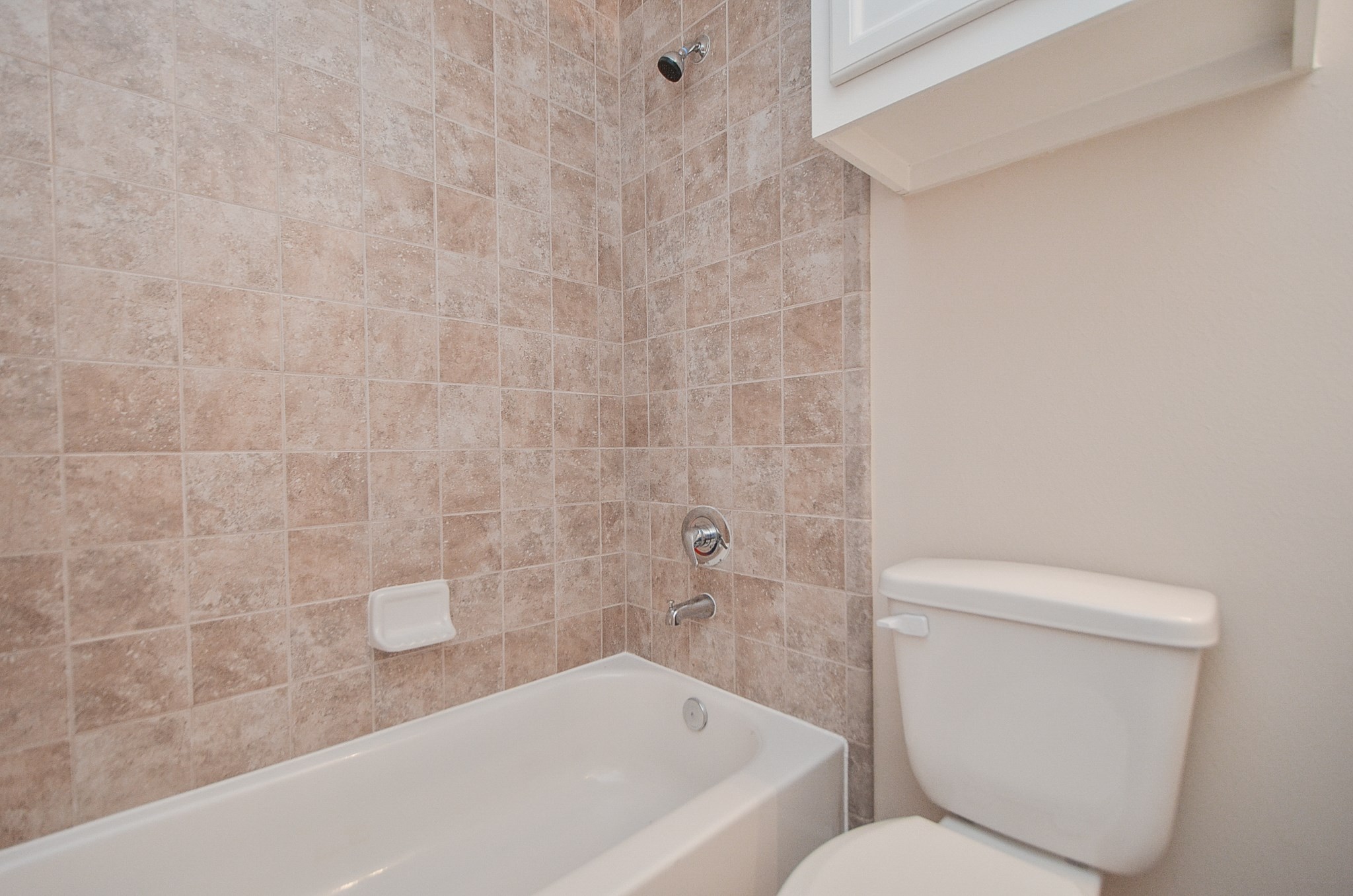 Both secondary bedrooms share a full bathroom with a large tub/shower combo,  and cabinet storage throughout.
