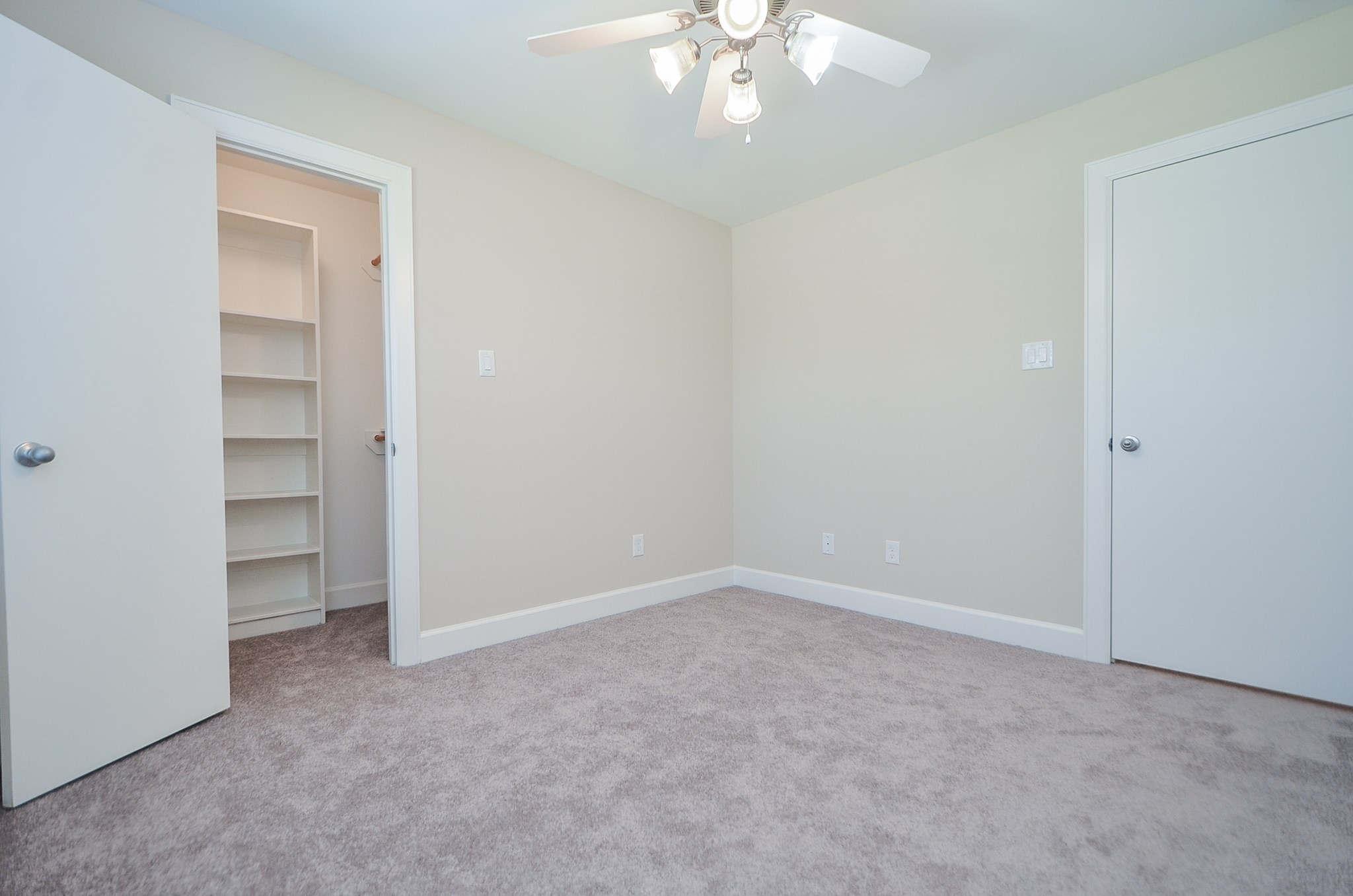 Secondary bedroom number two with a walk in closet and a built in shelf.