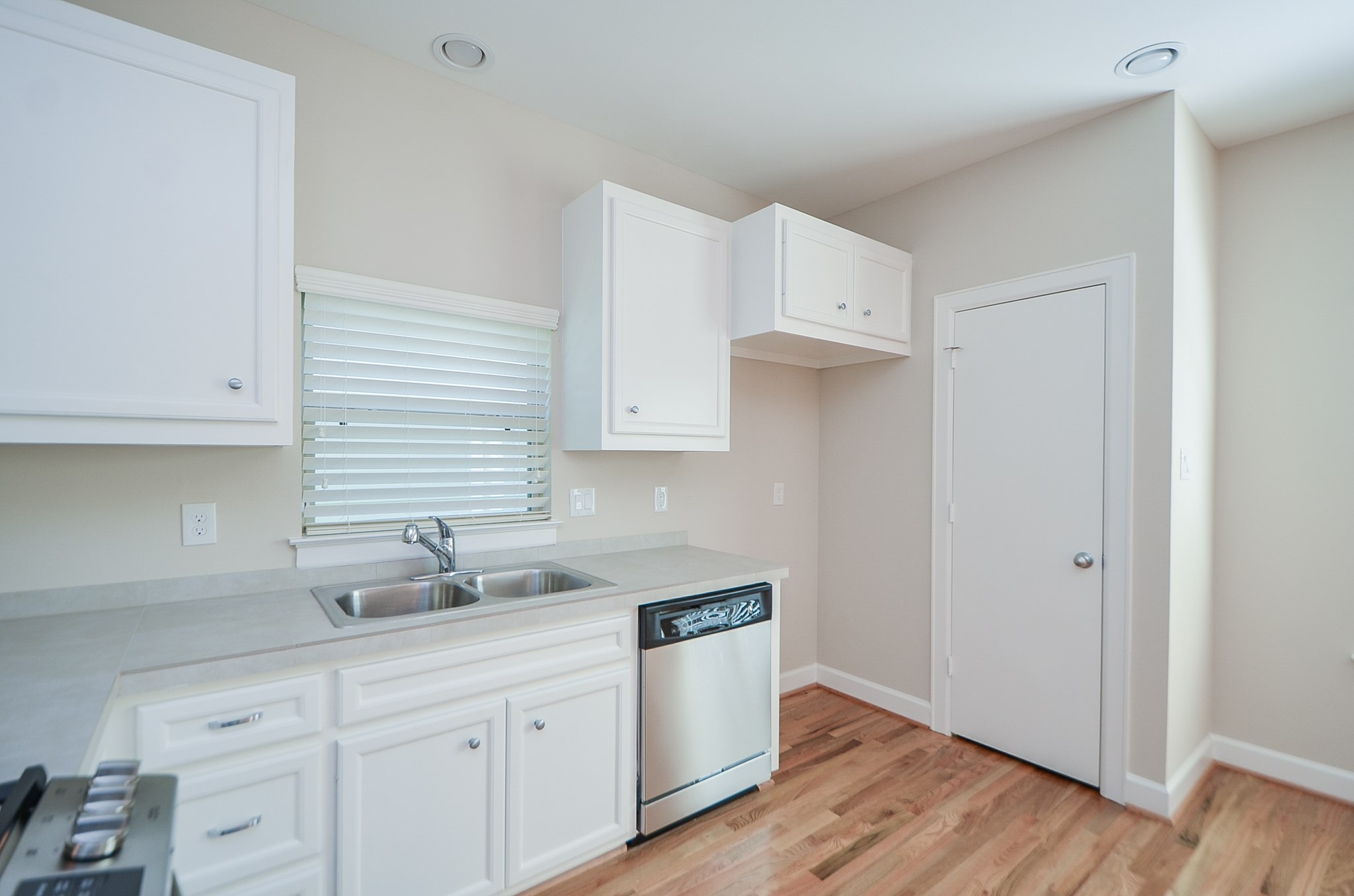 All appliances are conveyed with the home including washer and dryer. Photo is from previous listing and does not show stainless steel refrigerator currently in home.  The pantry is located behind the door currently in view.