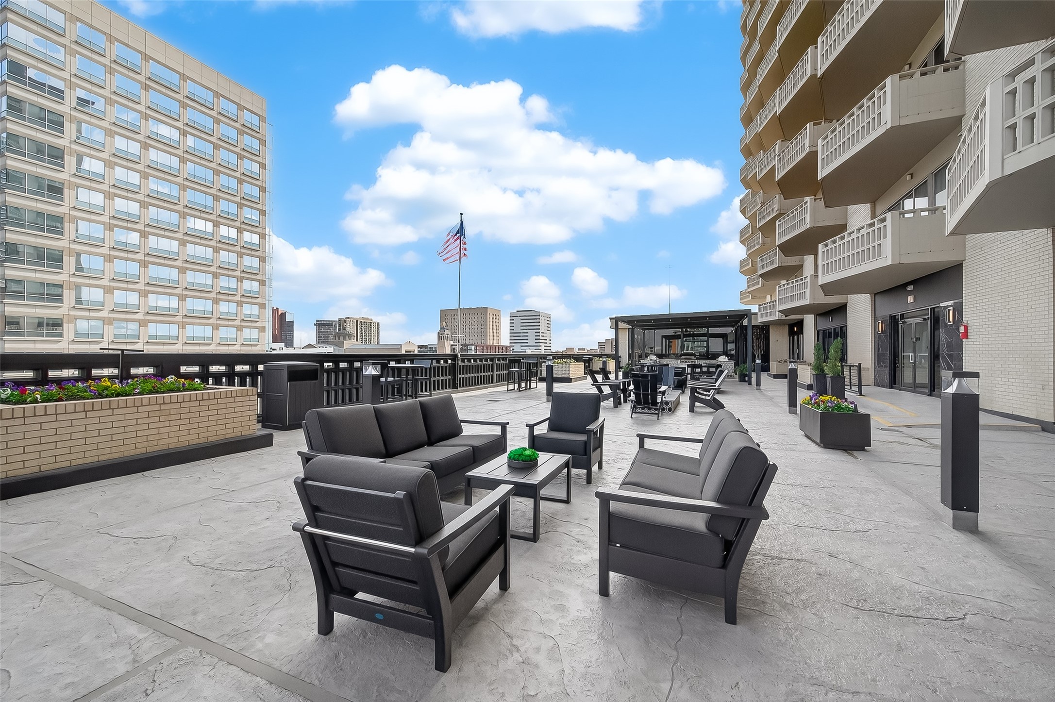 Spacious urban terrace featuring modern outdoor seating and stunning city views, perfect for relaxation and entertaining.