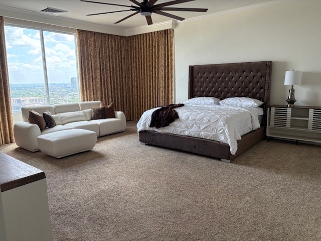 Spacious bedroom with a large window offering stunning city views, featuring a plush bed, cozy seating area, and elegant decor.