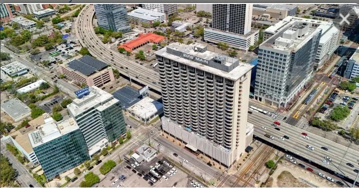 Experience urban living at its finest in a high-rise building surrounded by bustling city streets, modern amenities, and convenient access to major highways.