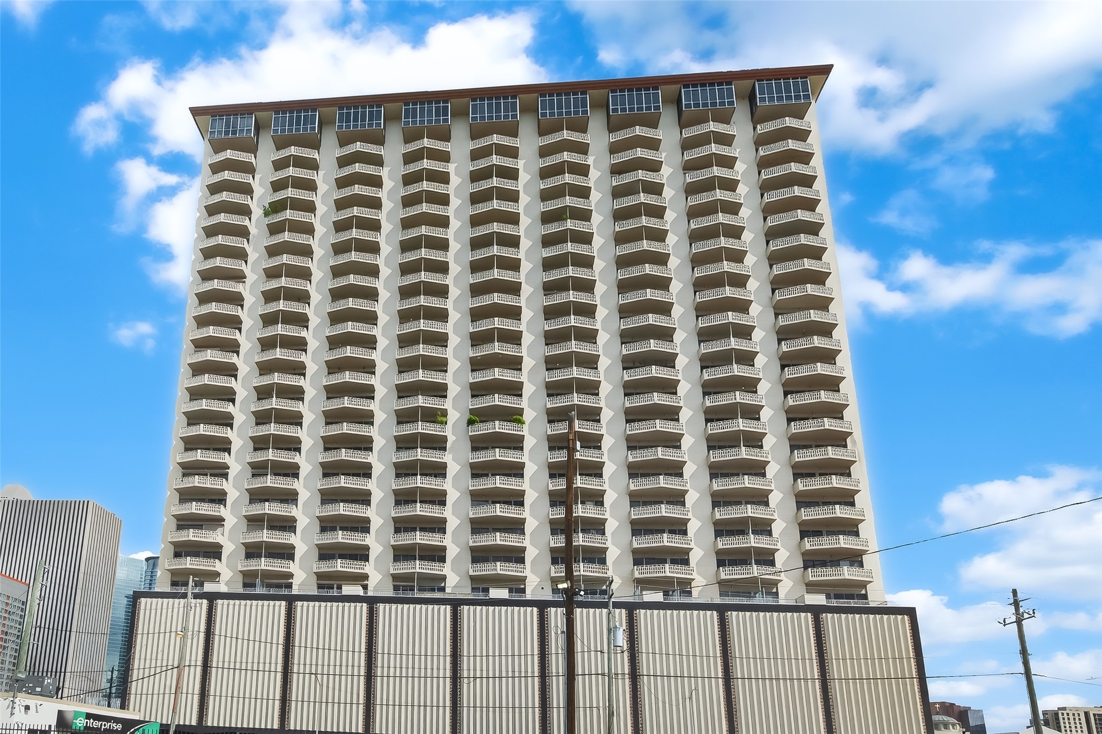 Stunning high-rise building featuring distinctive balcony designs, offering panoramic city views and modern urban living.