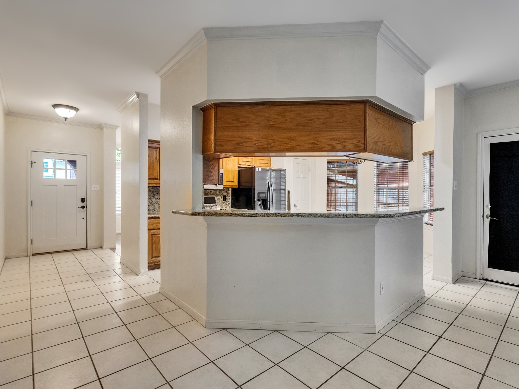 View of entry and kitchen equipped with a breakfast bar View of entry and kitchen equipped with a breakfast bar