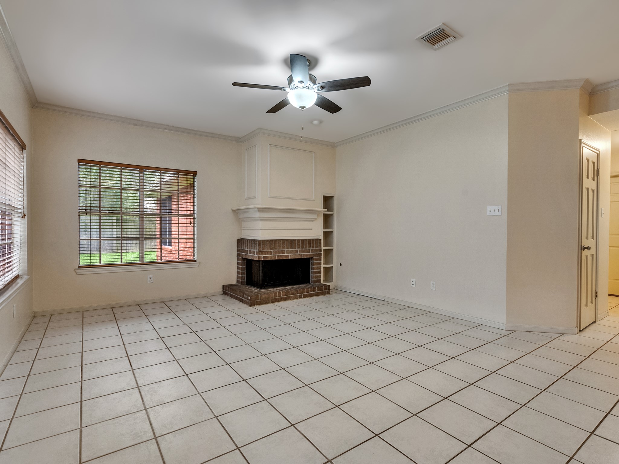 The living room comes furnished with a fireplace to stay cozy during winter nights and built-in shelving for books or photos
