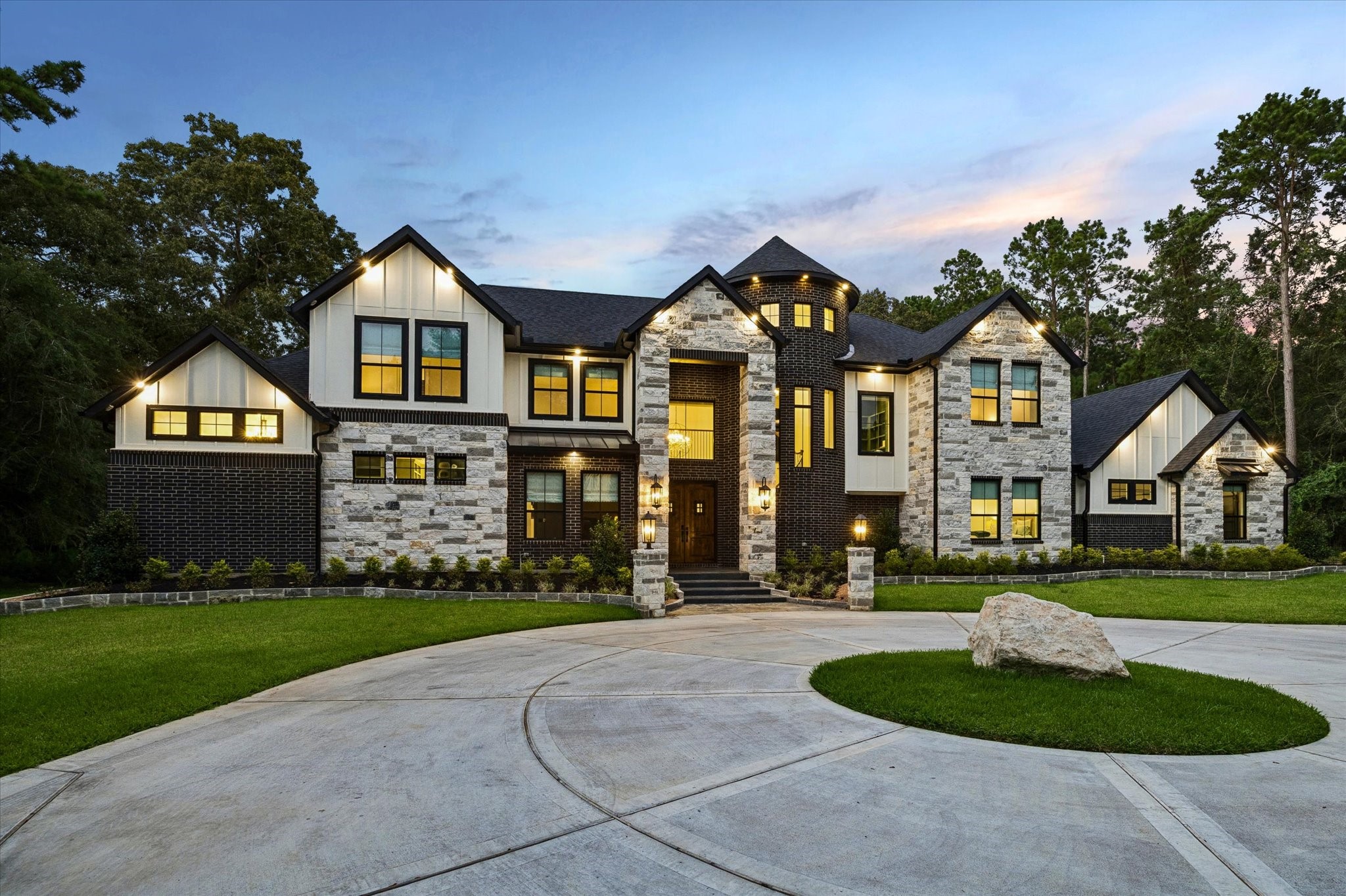 As you arrive, the home's striking exterior immediately commands attention. A timeless blend of premium brick, natural stone, dramatic rooflines, and elegant architectural details creates exceptional curb appeal. The oversized three-car garage complements the home's sophisticated design while providing outstanding functionality. Every exterior finish reflects the quality craftsmanship and attention to detail that continue throughout the entire residence.