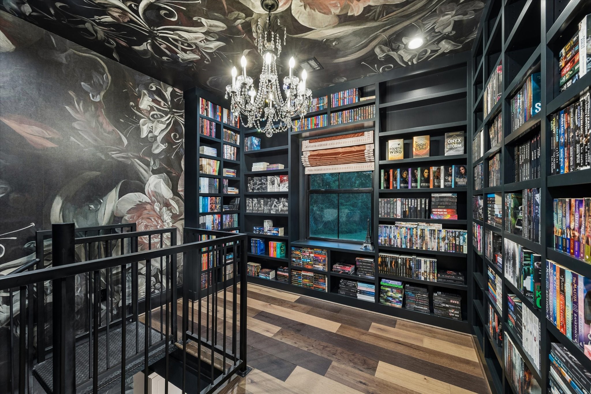 This remarkable library is a true statement space, where custom adjustable shelving, dramatic designer wallpaper, and artisan craftsmanship create an extraordinary setting for treasured collections, and quiet reading.