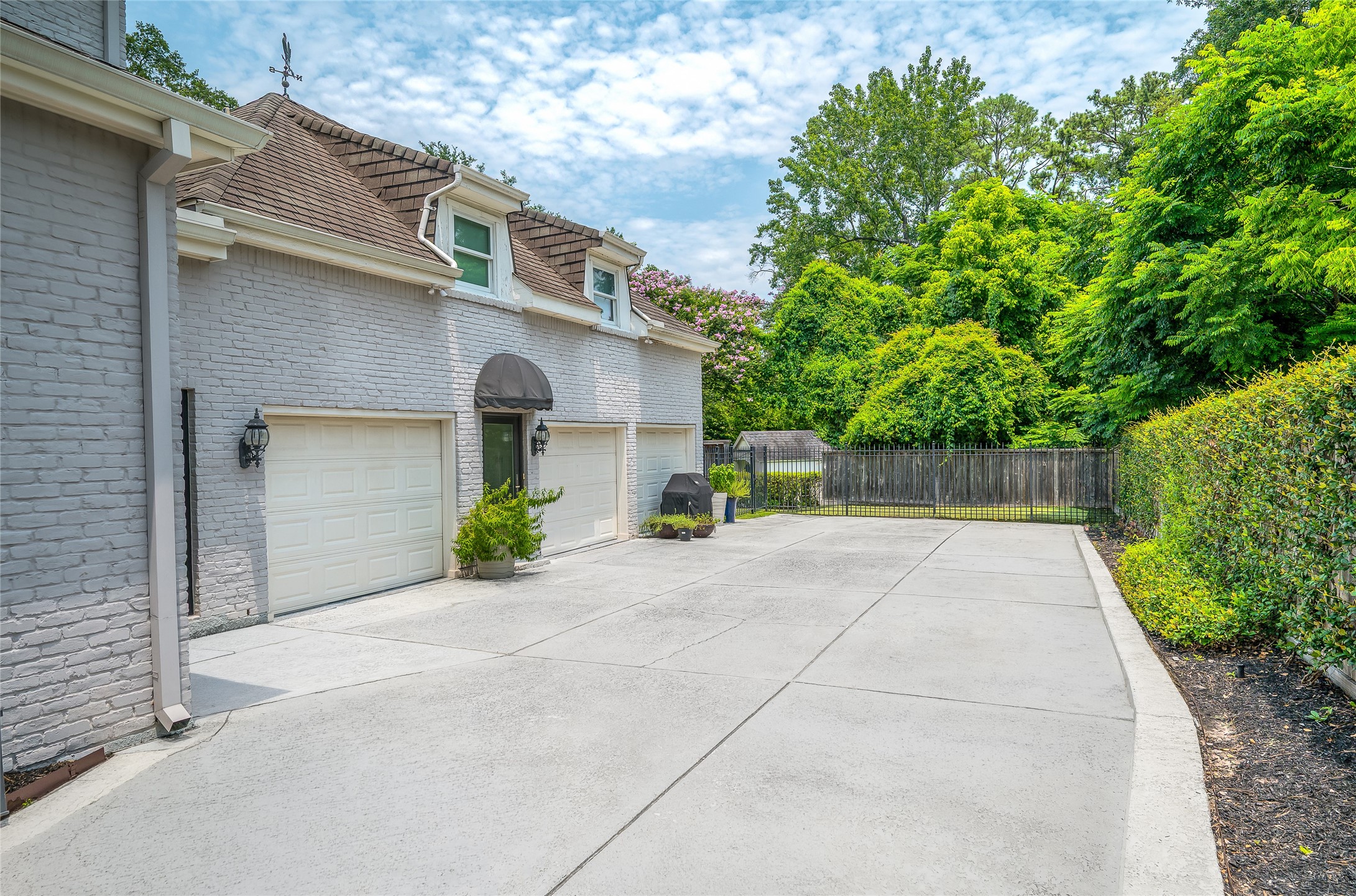 [Garage and Motor Court]
The garage has 3 bays for cars. Door with awning opens to garage and staircase to garage apartment.