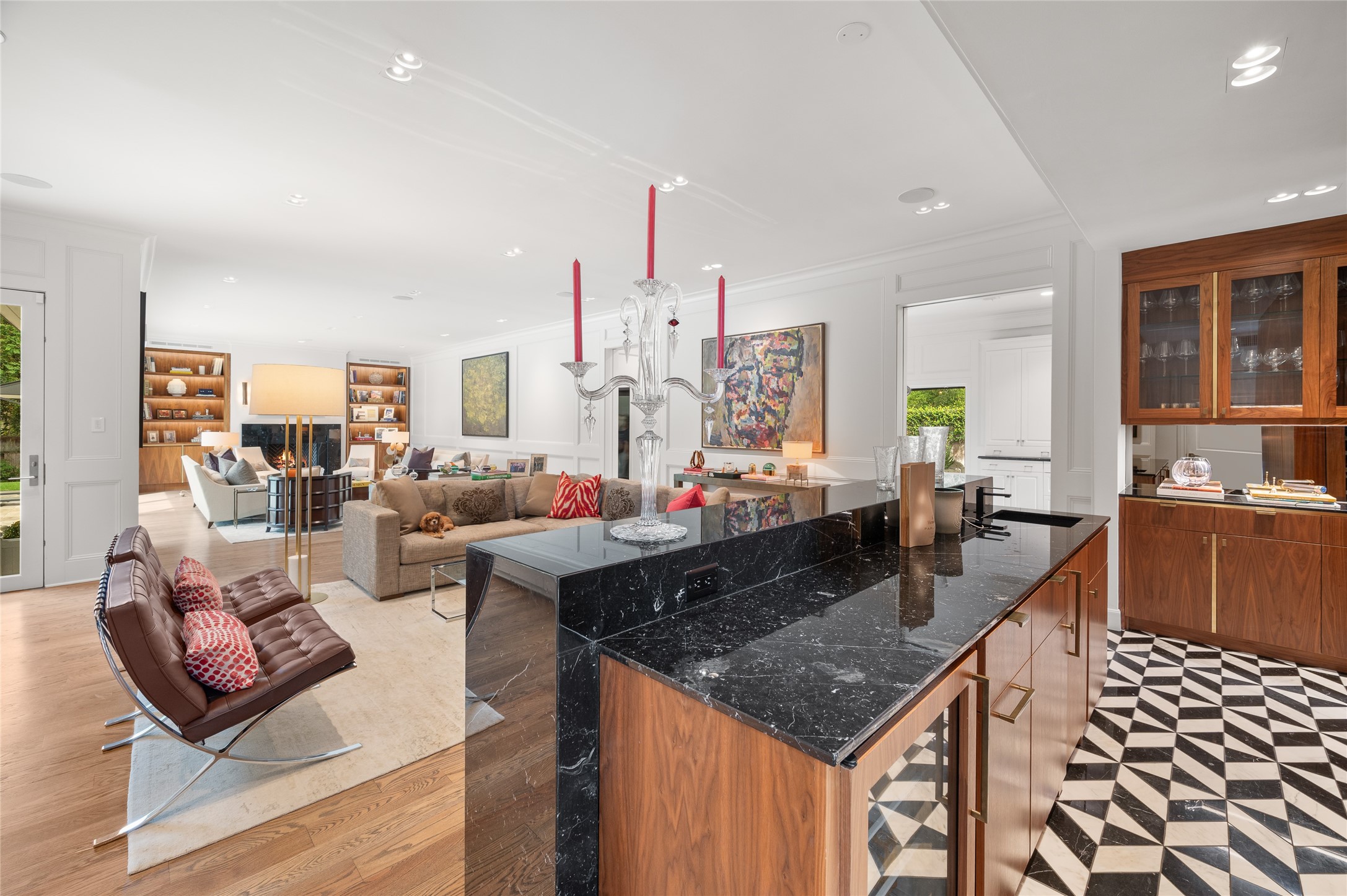 [Full Bar and Family Room]
This view travels across the bar into the expansive family room with two conversation/seating areas.  Note under-counter chiller in bar beneath Nero Marquino countertop. Two sets of open pocket doors (at right) reveal the gathering kitchen.