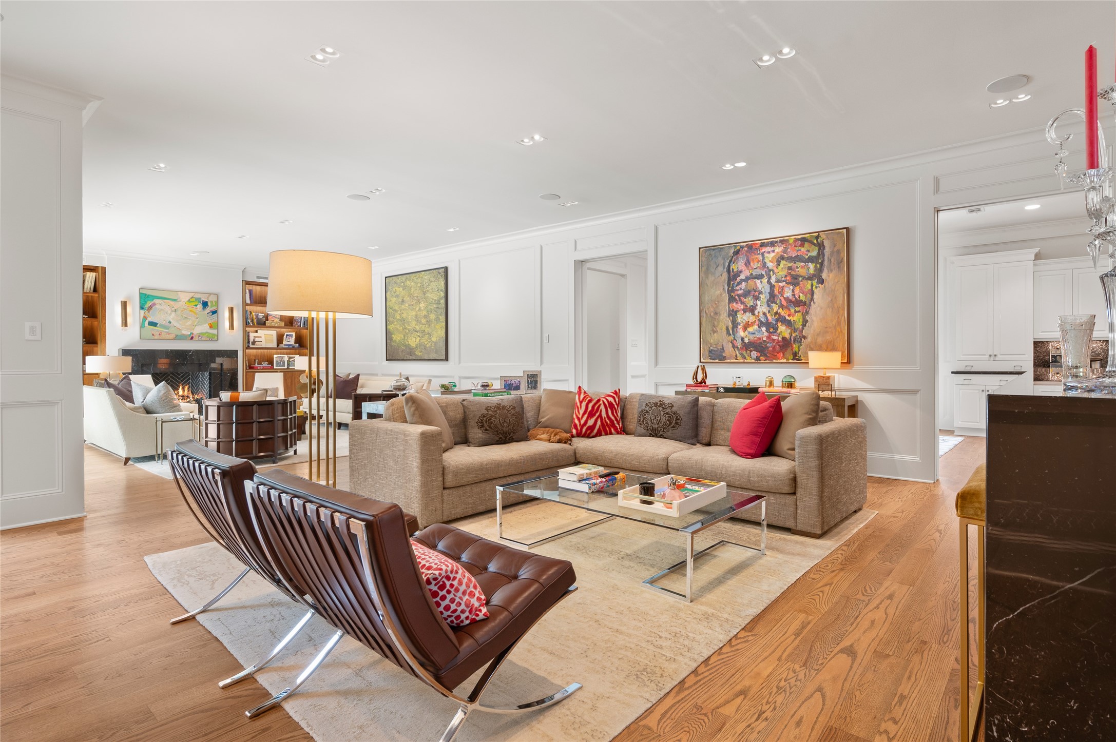 [Family Room]
The family room features a walnut floor, fireplace, walnut book/display cabinets, picture molding, and glass doors to the patios and pool.