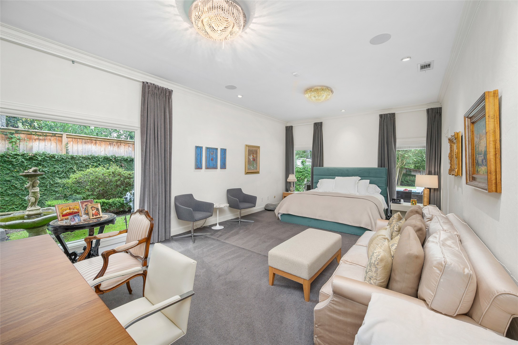 [Primary Suite]
This view reveals the picture window overlooking a fountain and gardens.