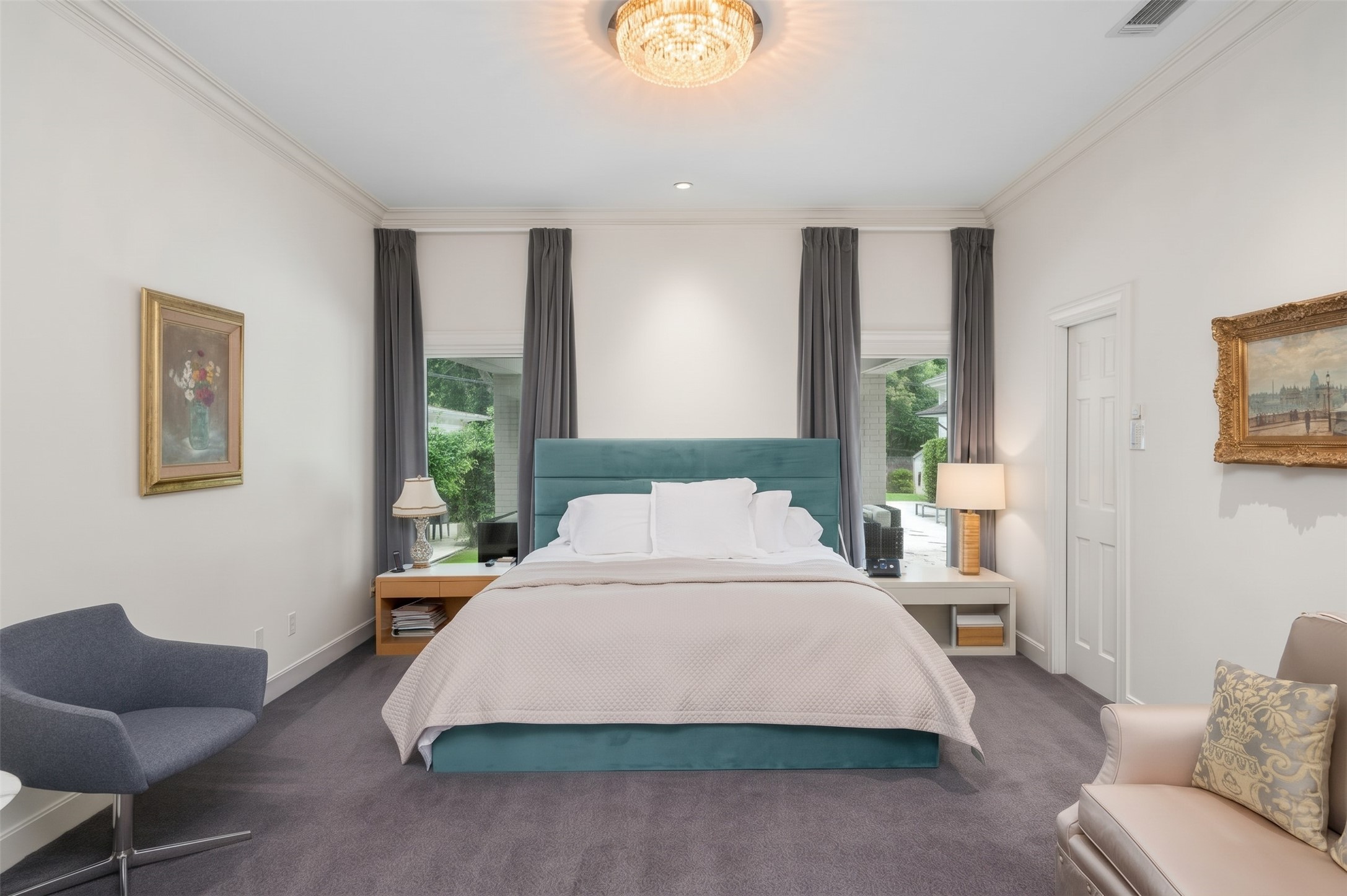 [1st-Floor Primary Suite]
Secluded primary suite on the first floor is surrounded by full0length windows and pool and garden views. Pocket door (left) opens to bath and walk-in closet.