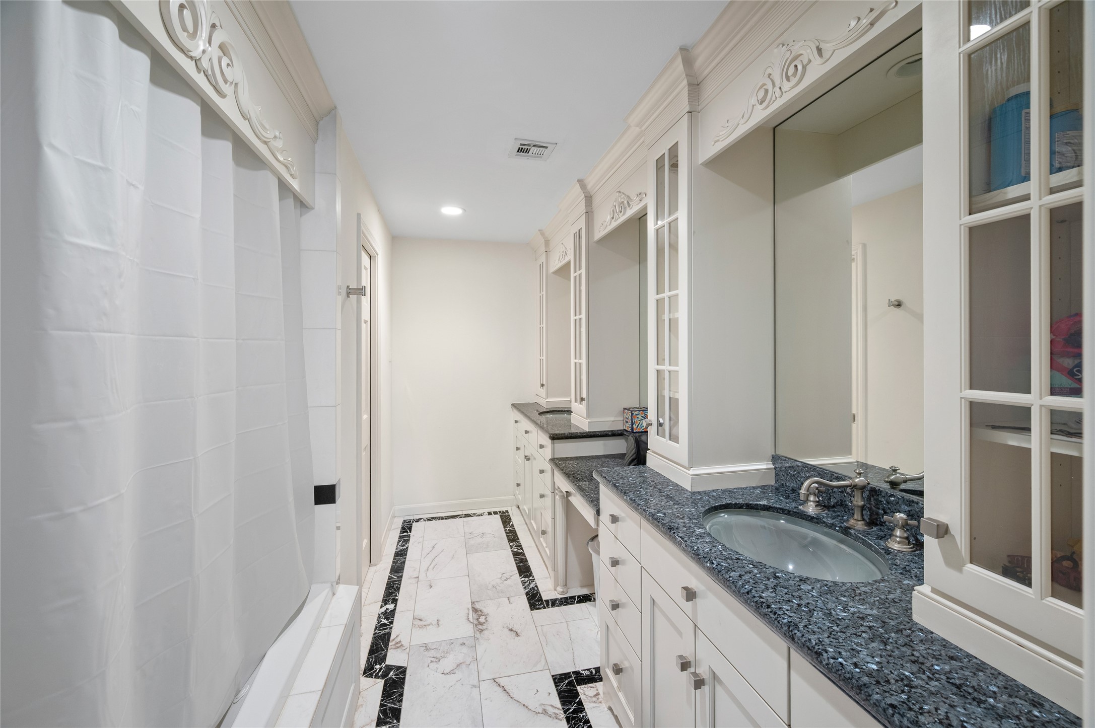 [En Suite Bath]
This en suite bath has granite sink decks, marble tile floor, and a tub/shower.
