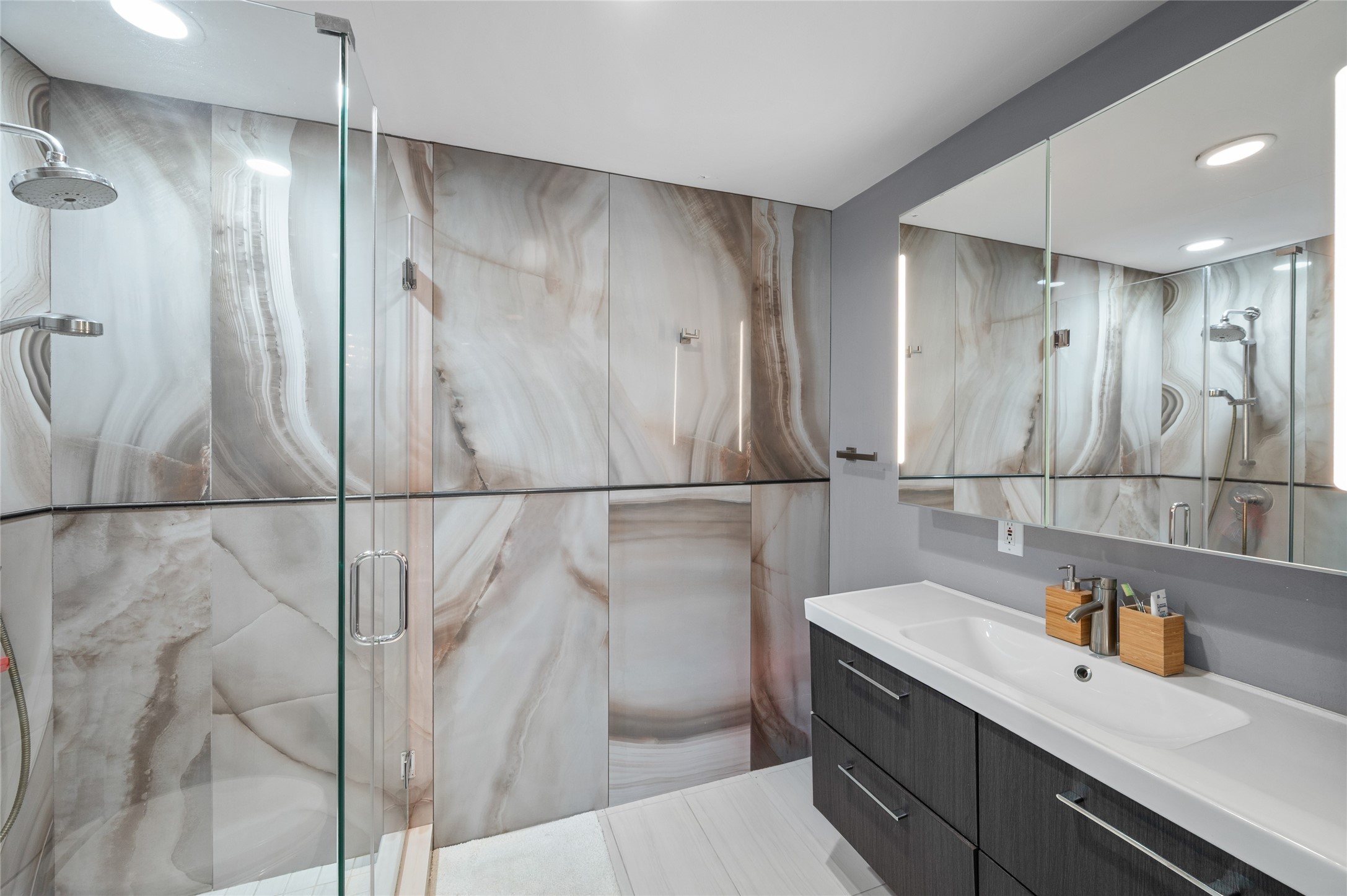 [En Suite Bath]
This bedroom's attached bath features a glass-enclosed shower and Italian Rex marble wall paneling.