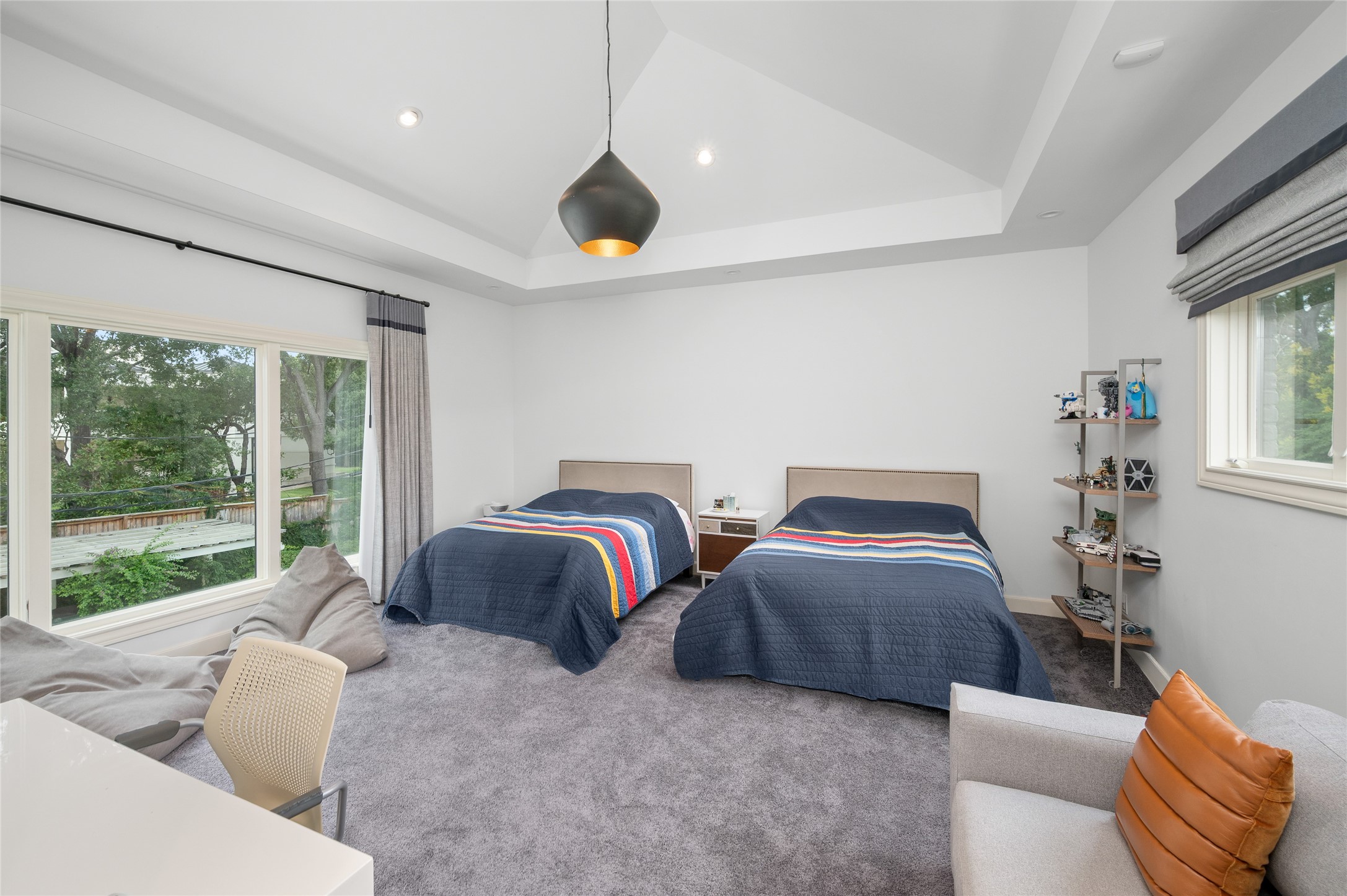 [En Suite Bedroom]
This bedroom has a wall of windows overlooking the pool and patios. Note raised ceiling. Amenities include a custom-fitted closet and attached bath.