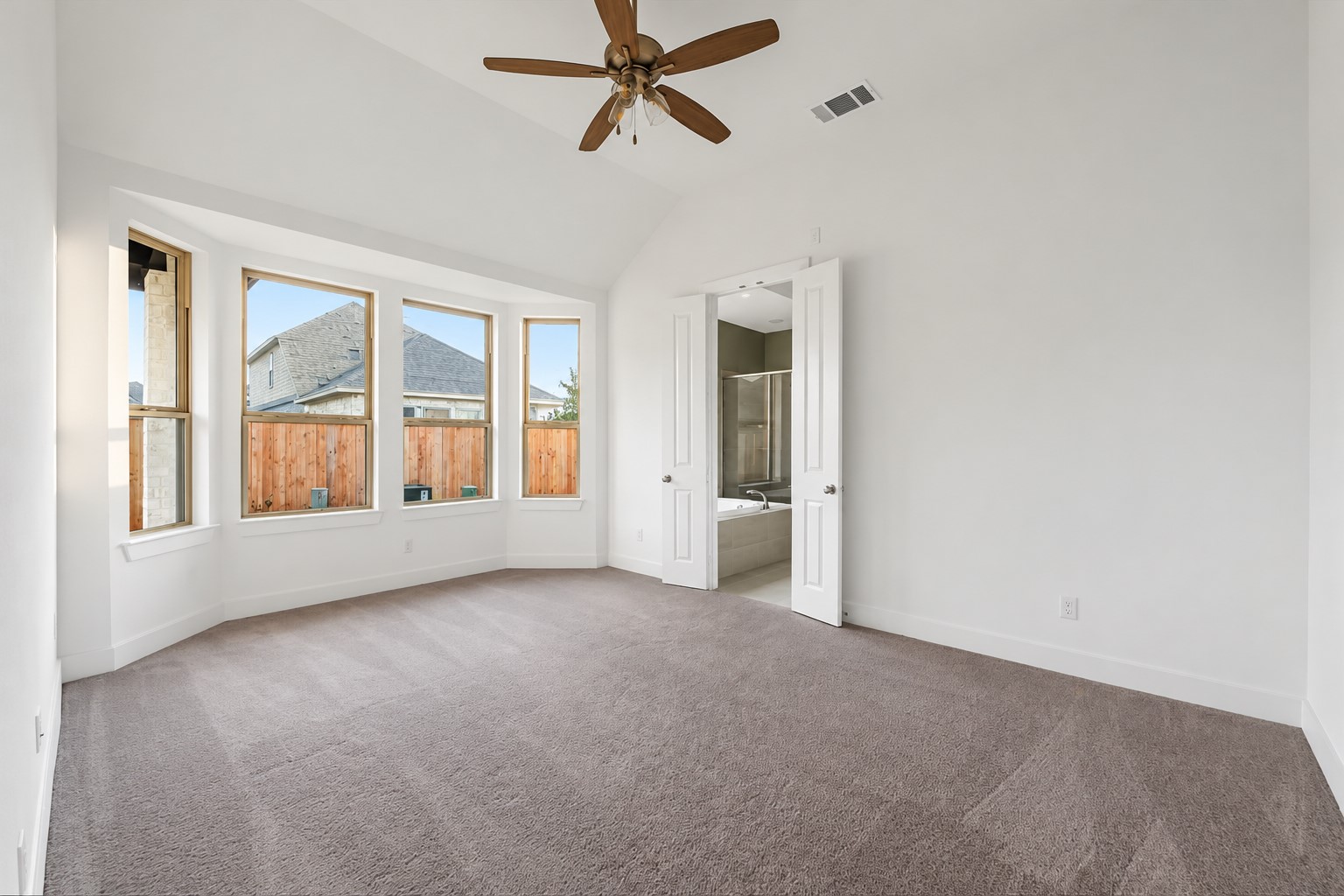 Spacious primary bedroom is tucked away in the back of the home.