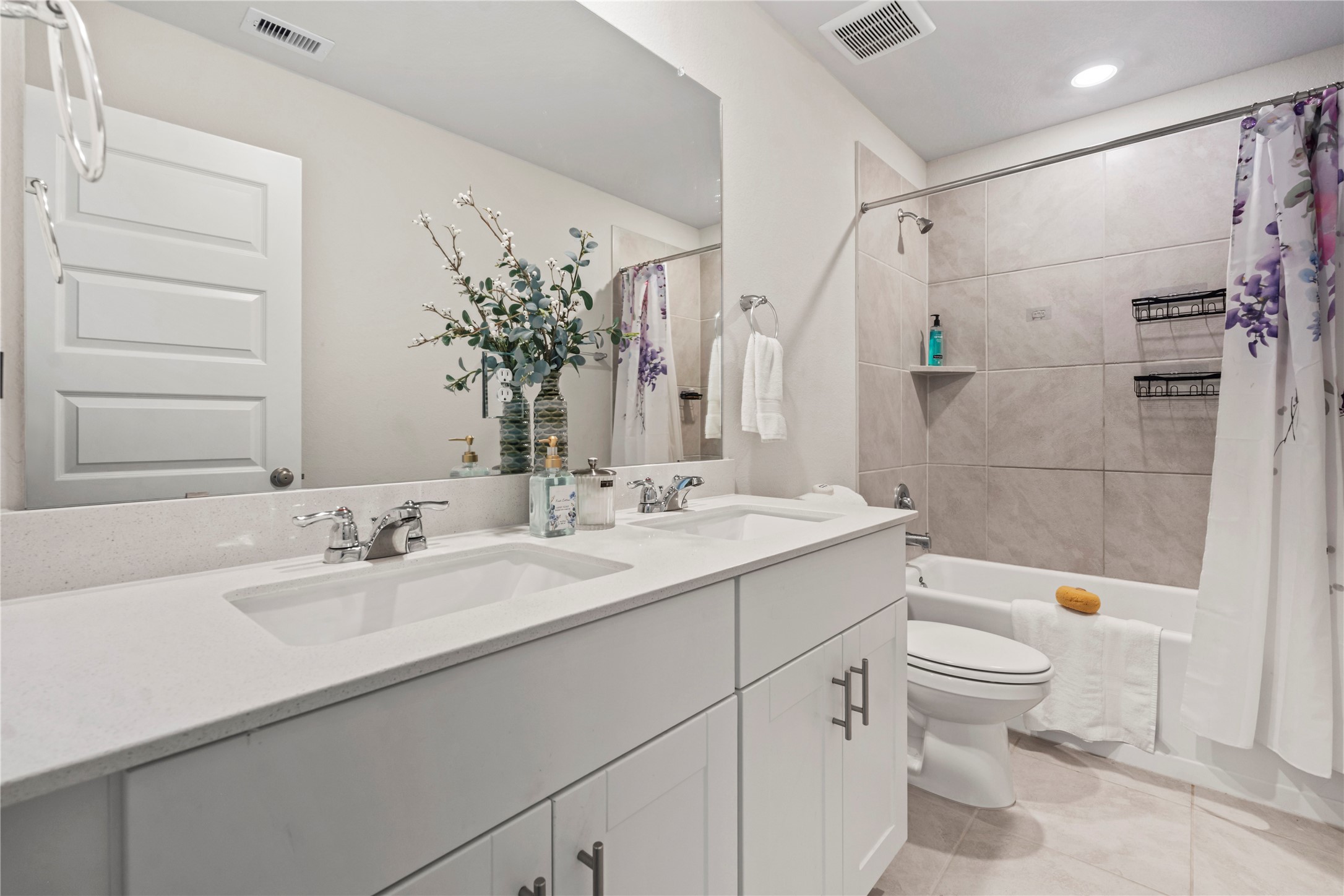 Fourth bathroom upstairs with double sinks.