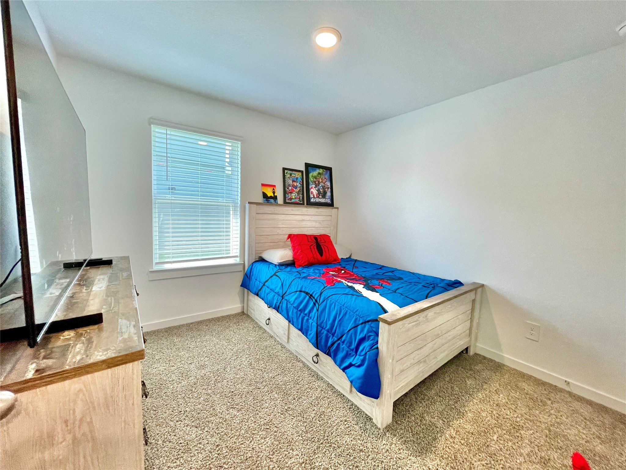 comfort meets functionality in this sunlit bedroom, showcasing excellent layout options and great natural light