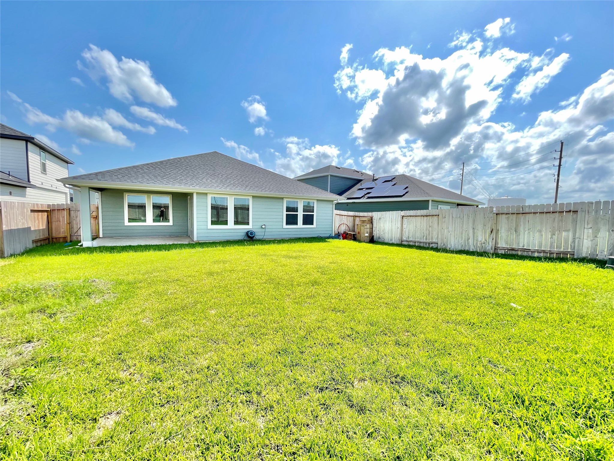 Rear elevation view highlighting the pristine condition of the home and the incredible scale of the lawn.