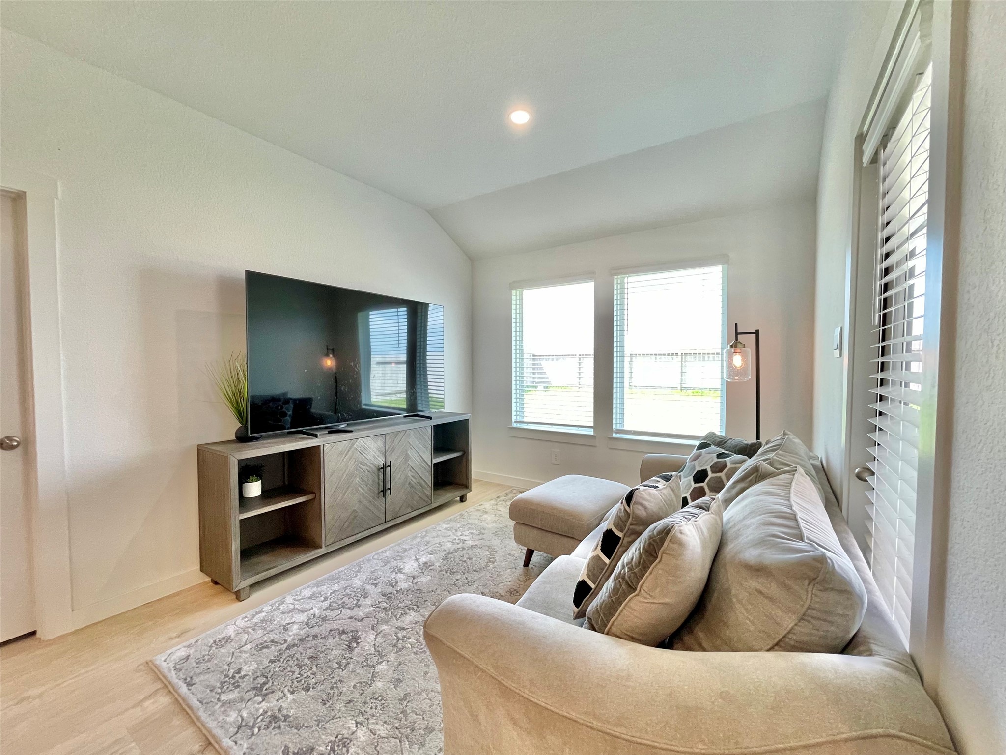 Large windows flood this intimate secondary living nook with a warm, relaxing afternoon glow.