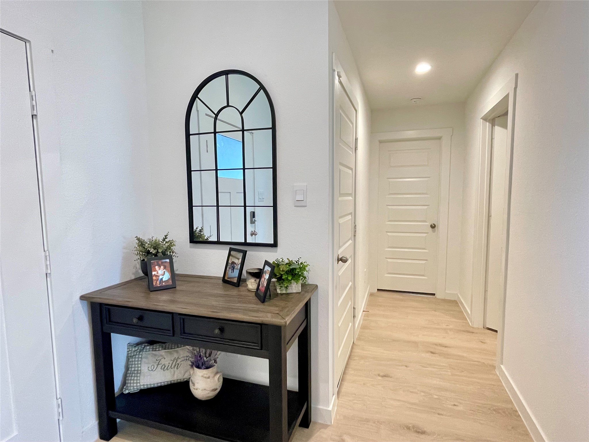 Elegant entry hallway featuring stylish accent furniture placement and a seamless transition into the heart of the home.