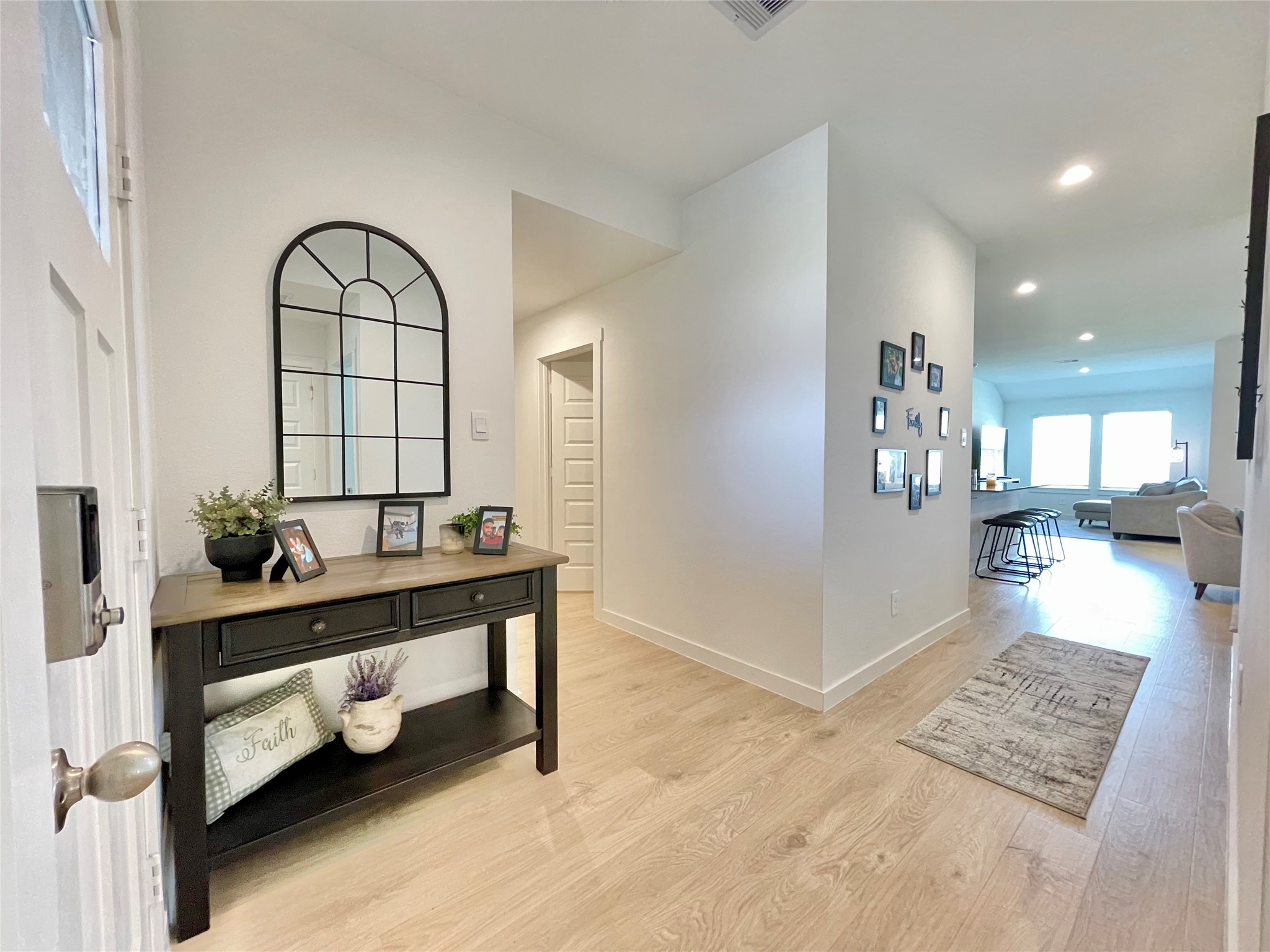 Step into a bright, airy foyer that immediately introduces the homes chic, contemporary aesthetic and open-concept flow.