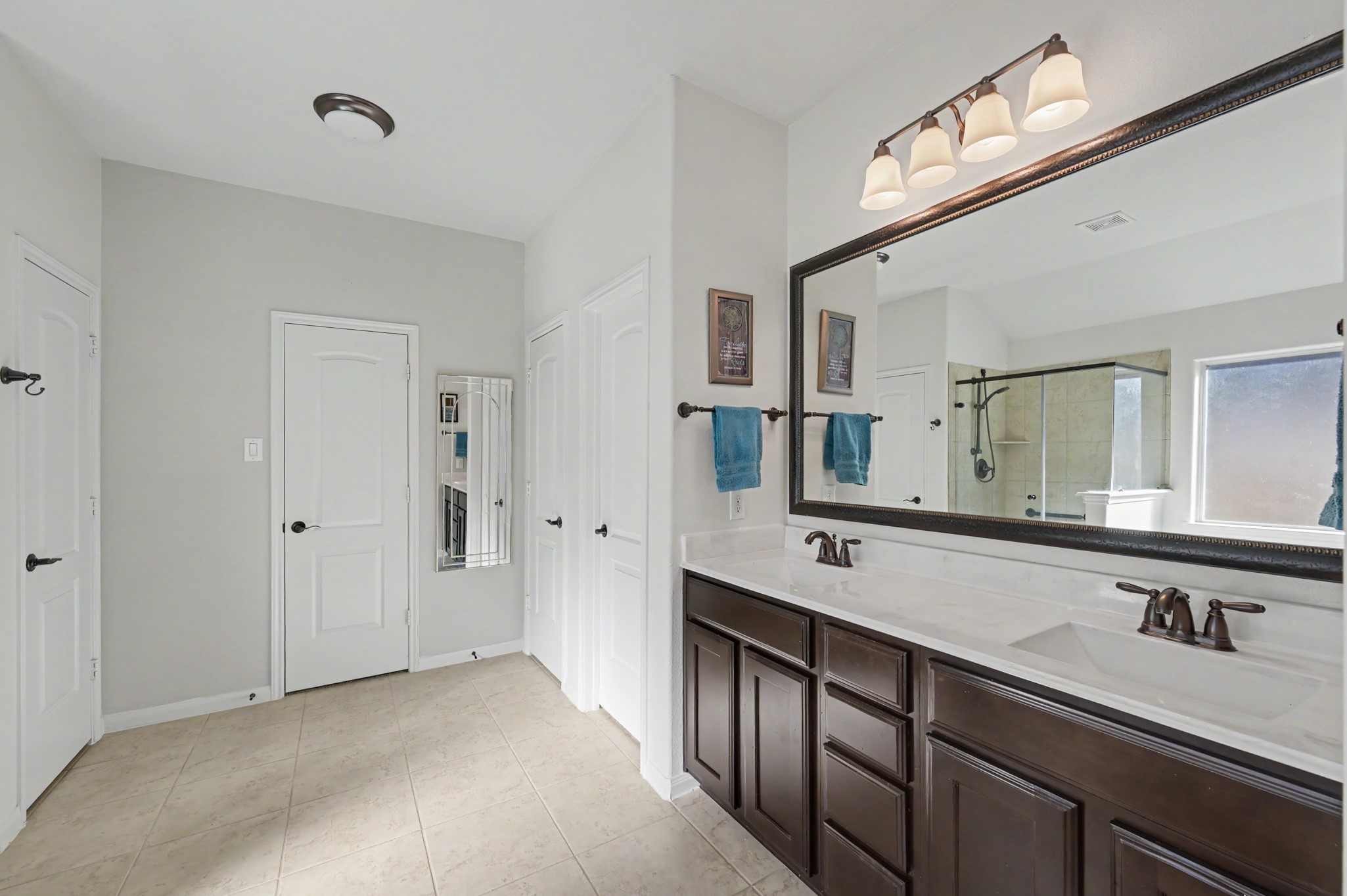 Grand primary bath with 2 closets & double sinks.