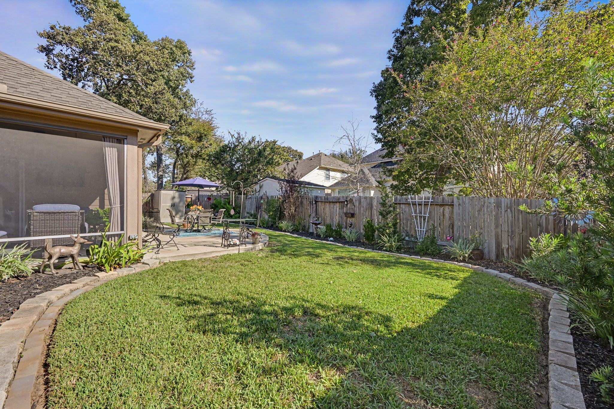 This yard offers it all.  Screened porch, extended patio & plenty of grassy space for play.