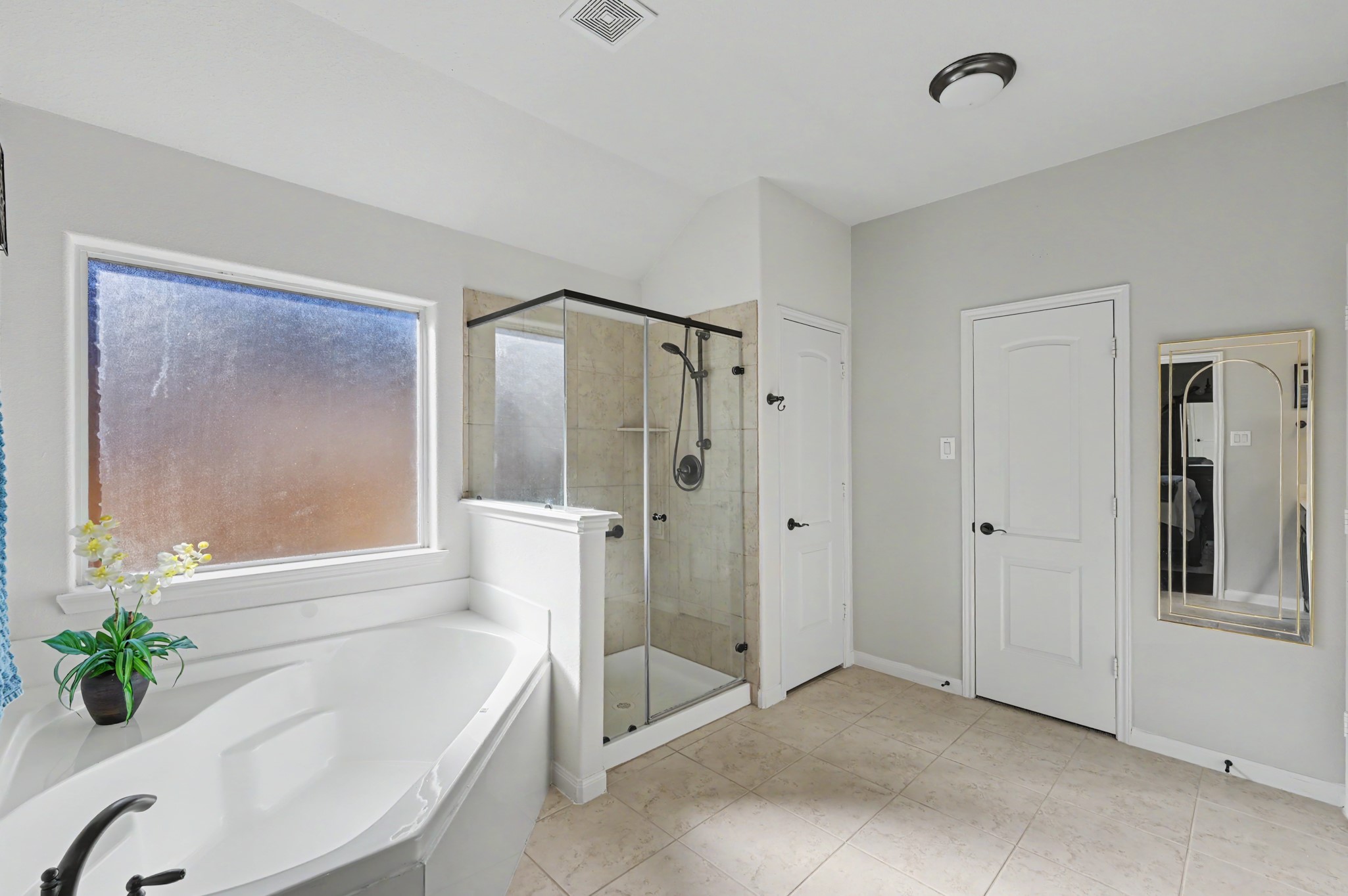 Primary bath has garden tub & stand alone shower.