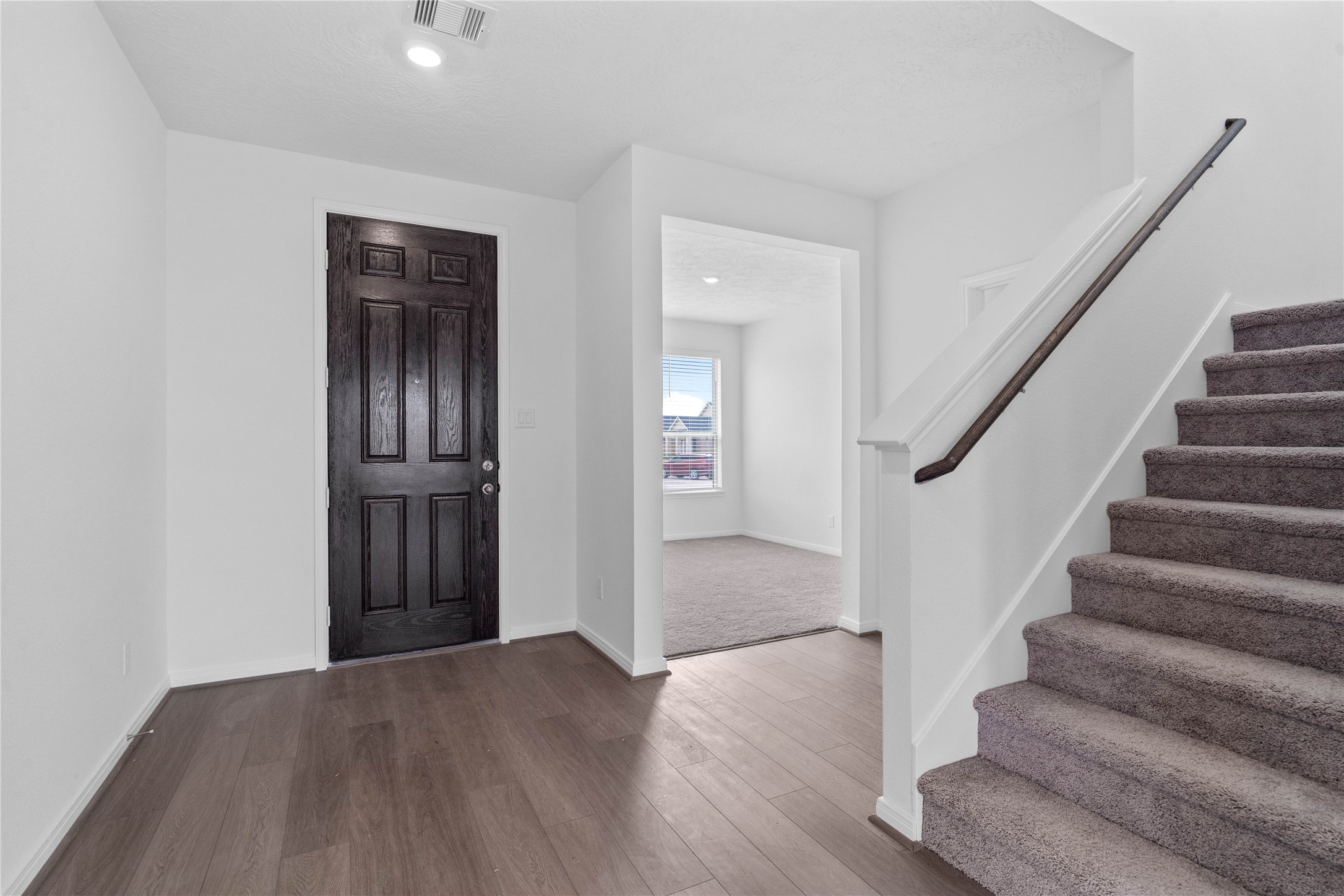 Welcome home to a bright, modern entryway that perfectly sets the tone for this beautiful property. This inviting space features high-quality vinyl plank flooring that blends style and durability seamlessly.