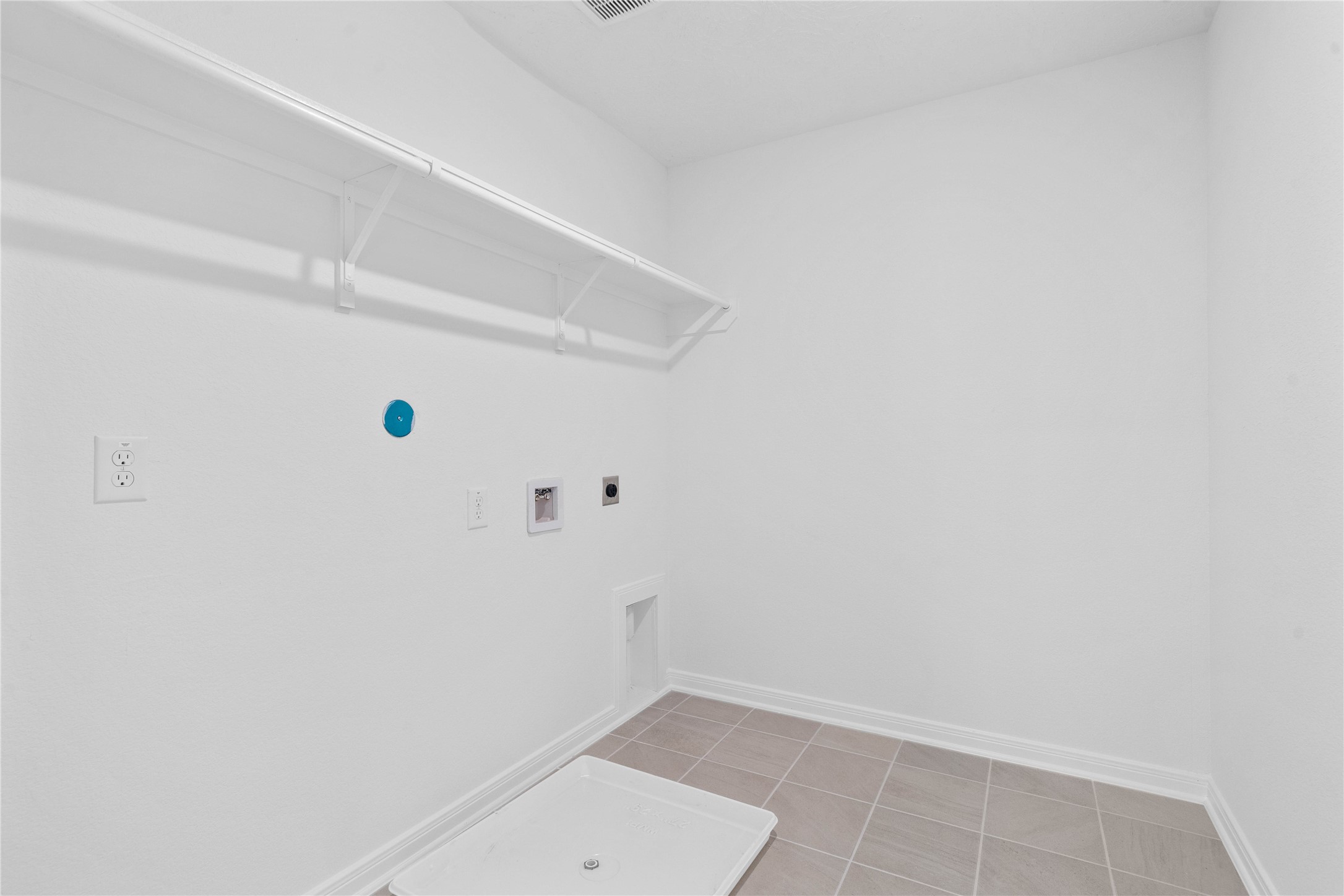 Laundry room conveniently located in the second level.