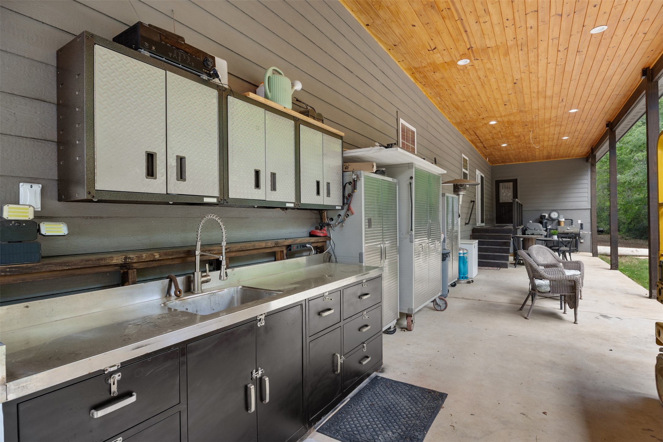 The cabinetry extends onto the back porch. Running water and sink to prepare outdoor feasts