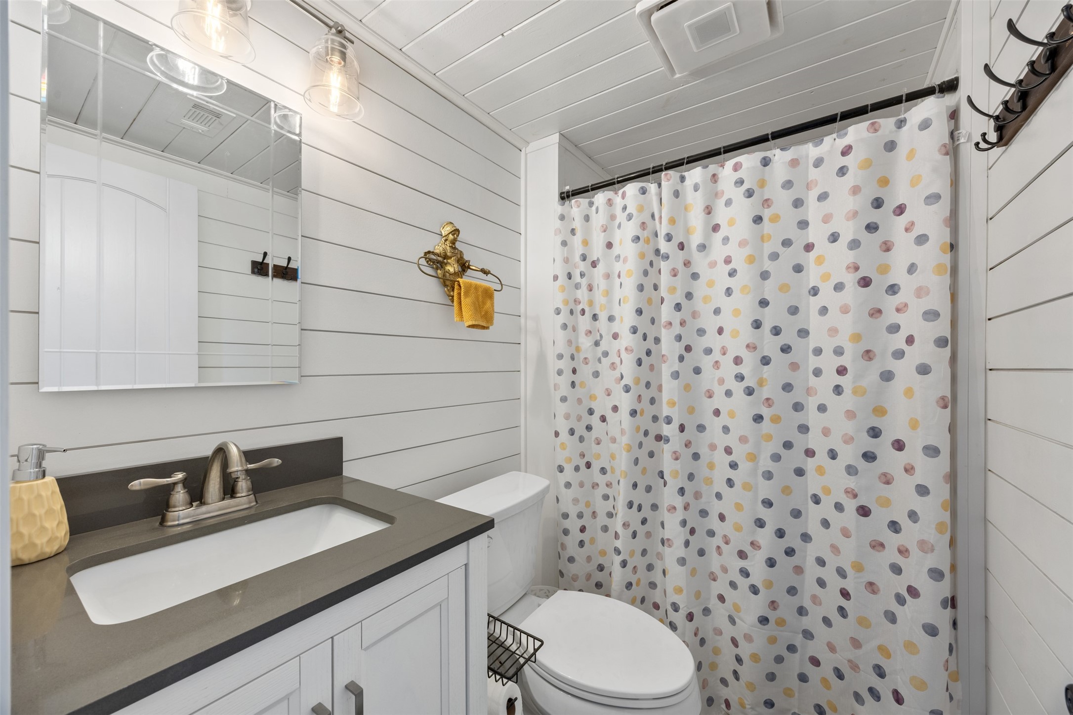 Guest bathroom shines with new lighting, shiplap walls. Beautiful country feeling