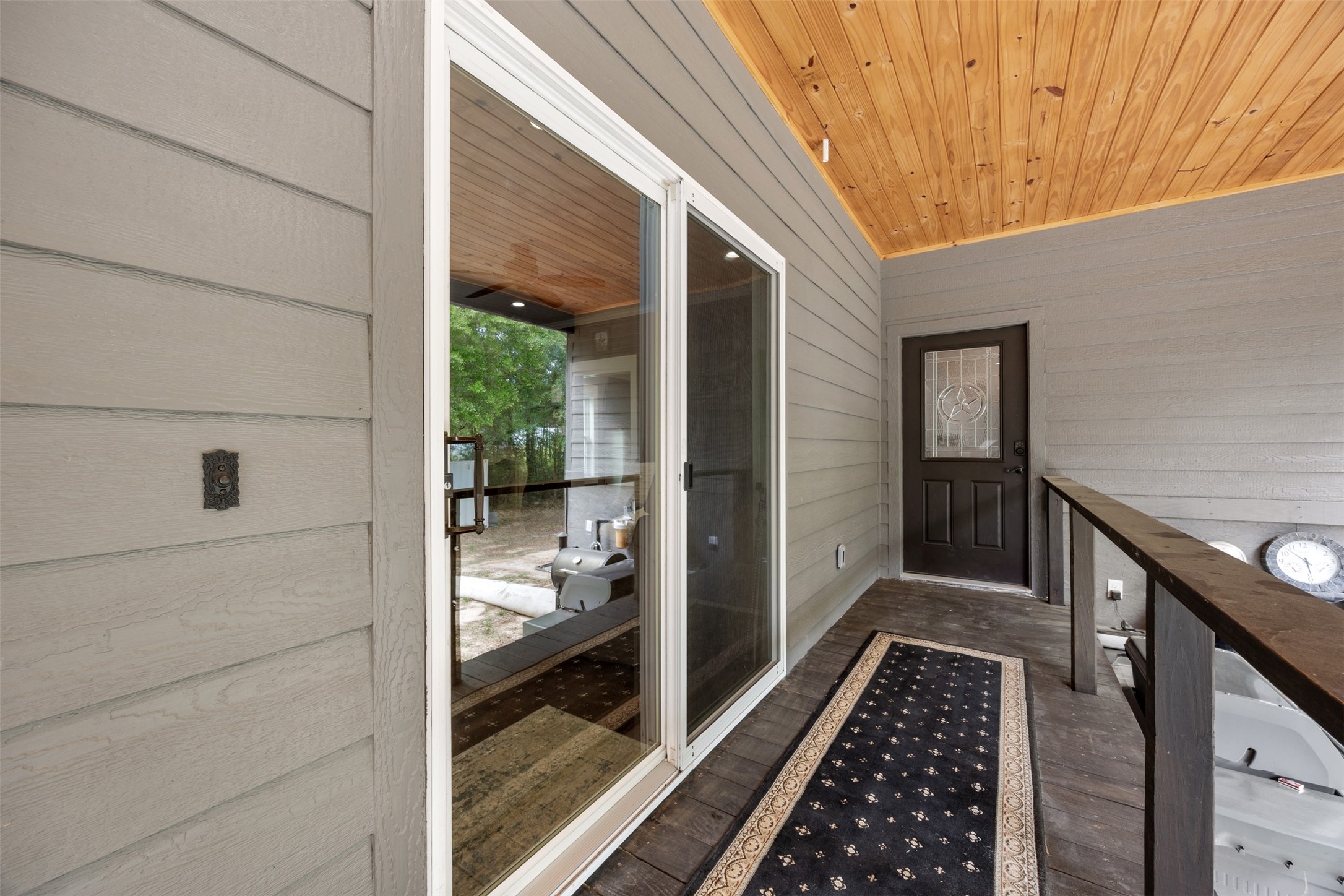 Second view of the back porch entering into the family room from the glass door