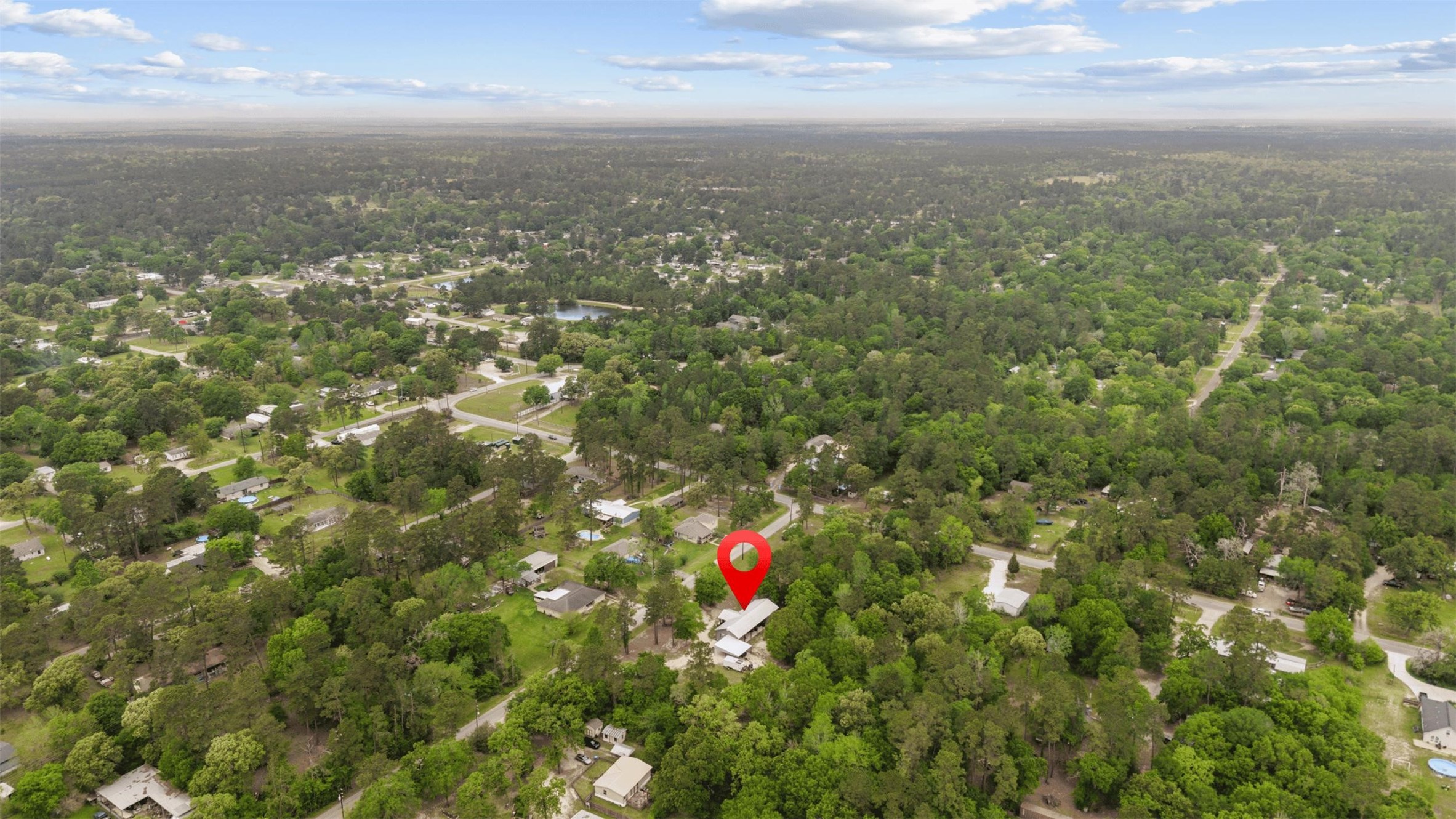 Aerial view of the property nestled within the trees of Magnolia
