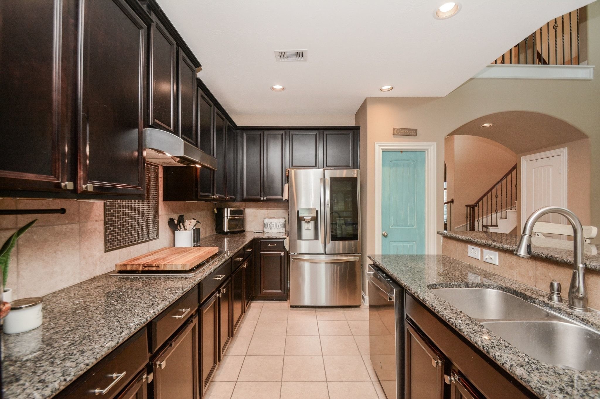 Stainless steel appliances, 4 burner gas cooktop, built-in microwave and oven.