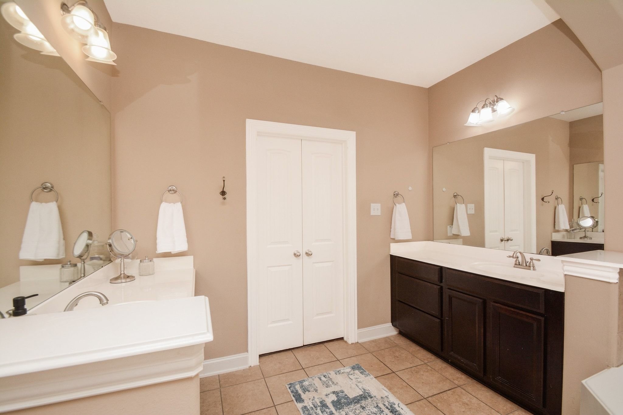 Double vanities, brush nickel fixtures.