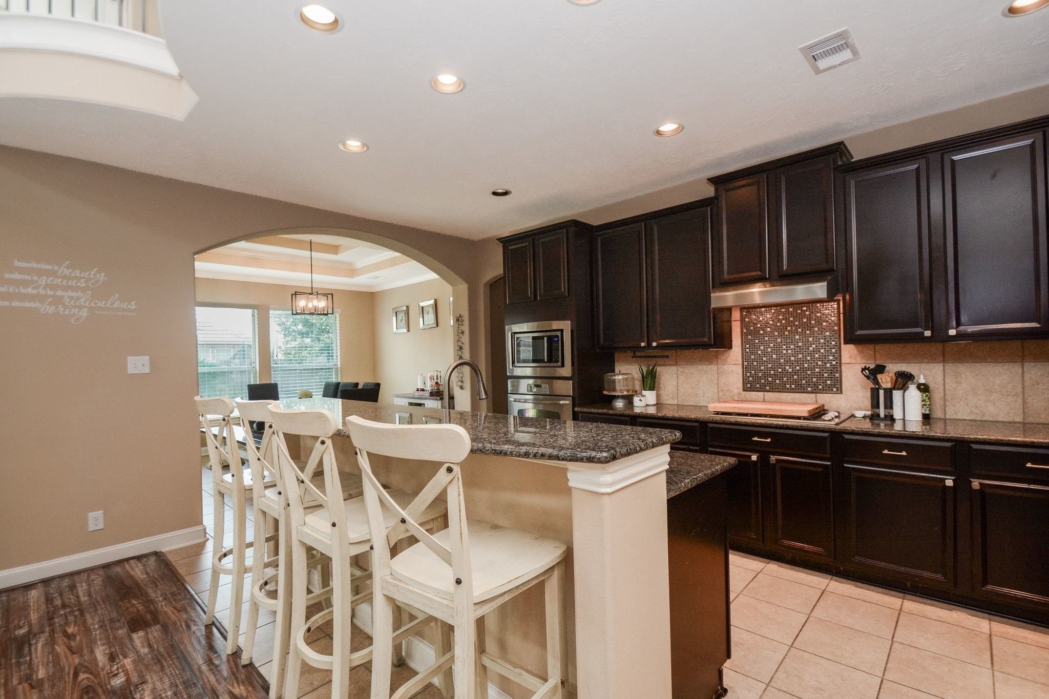 High low kitchen island with granite counters.