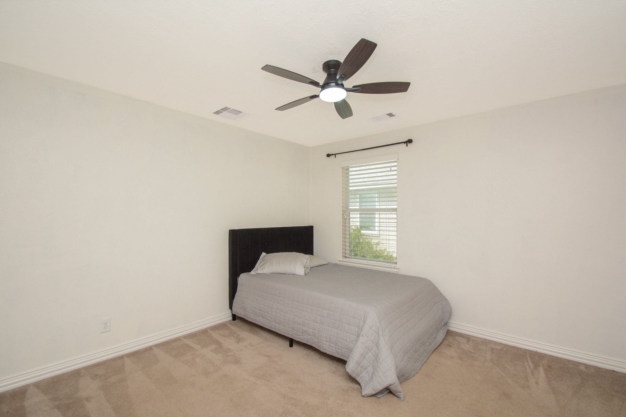 Secondary bedroom with fan attached to hollywood bath.