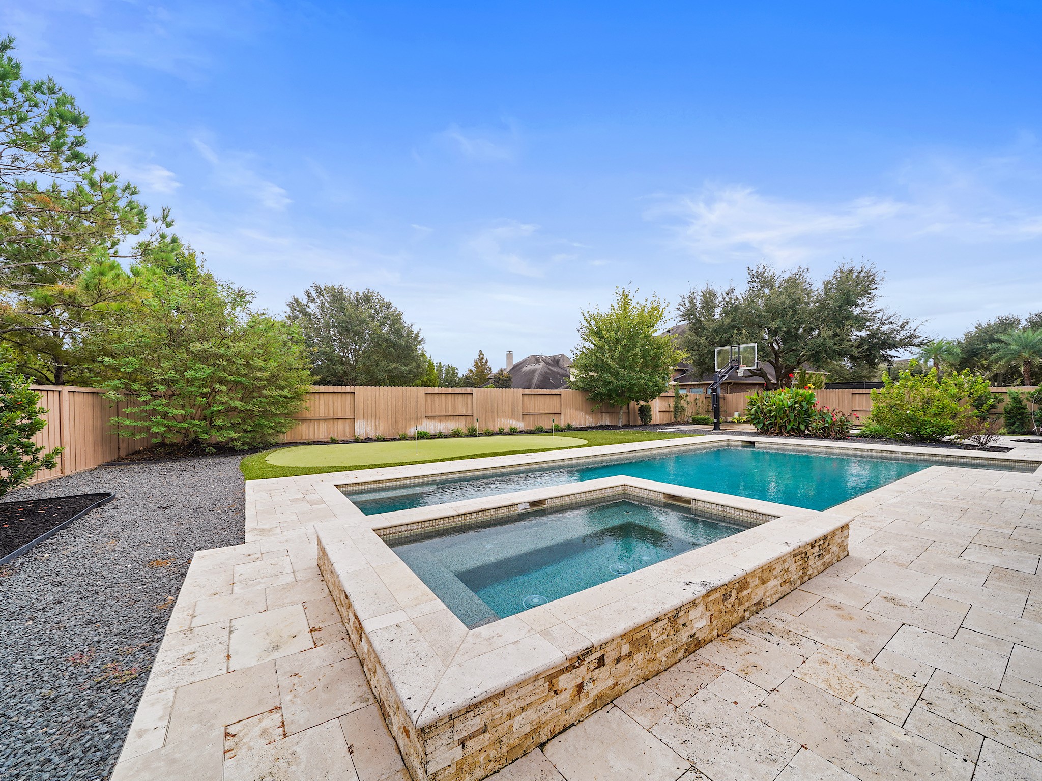 The heated pool and elevated spa become the centerpiece of the backyardequally inviting for a morning dip or a late-evening soak.