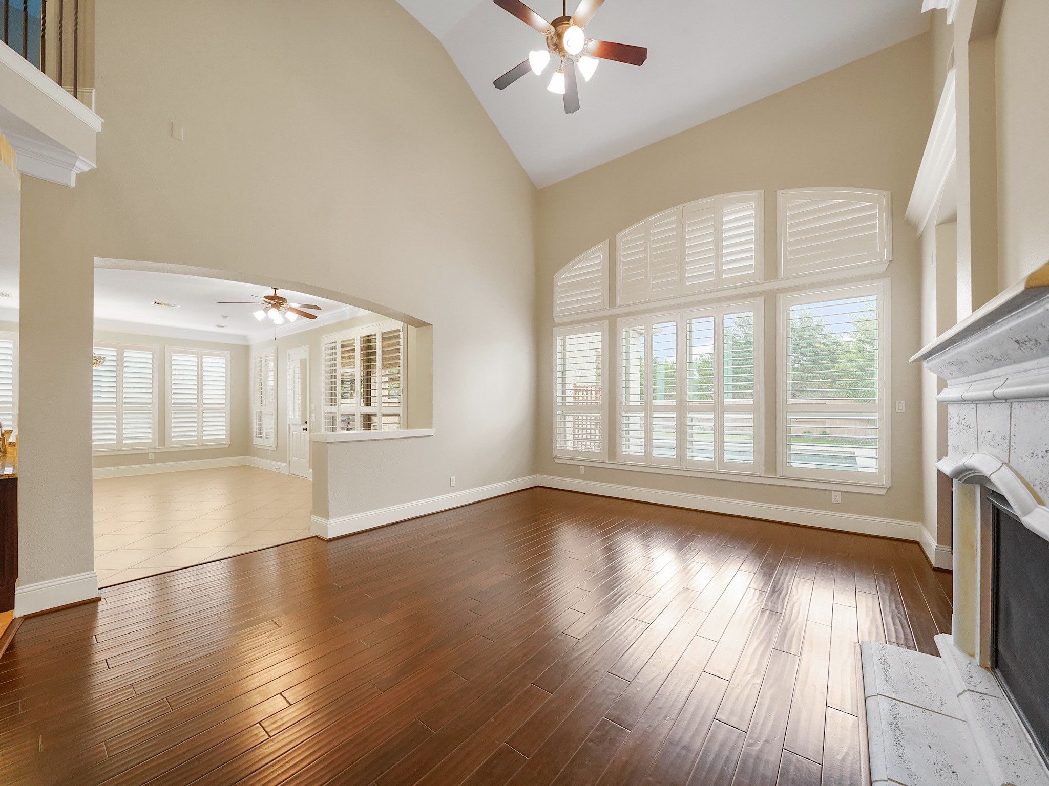 Arched, floor-to-ceiling windows fill the family room with natural light.