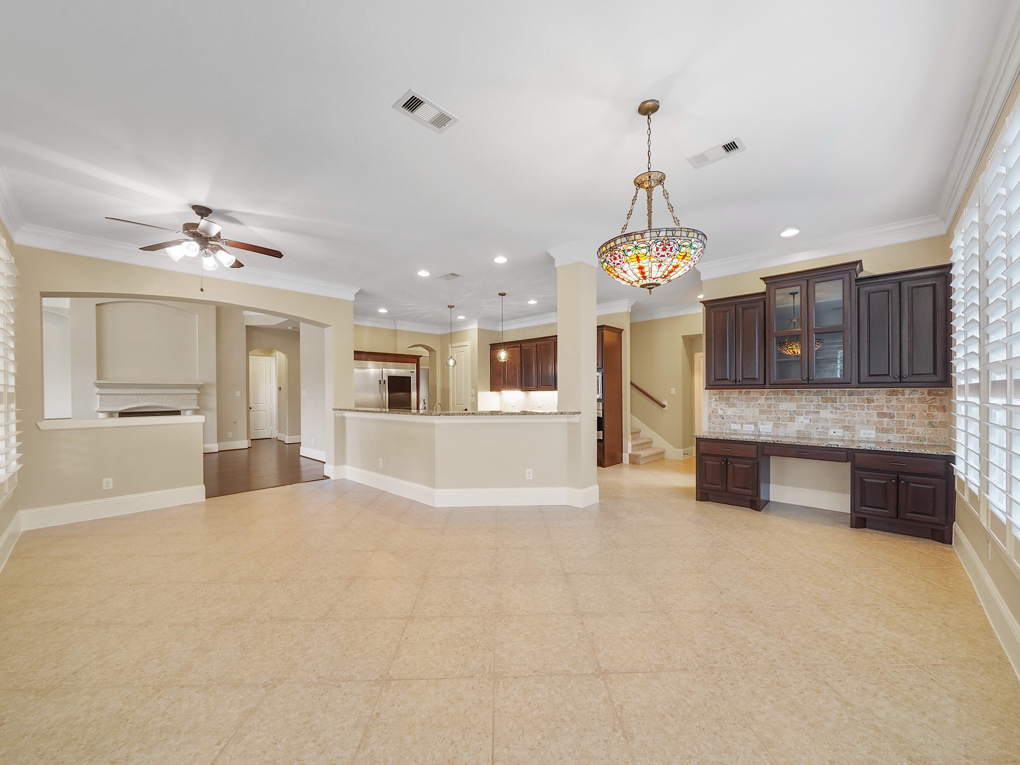 Beyond the kitchen, the generously scaled breakfast area leaves room to linger, with a built-in workstation tucked in for homework, planning, or a quiet day of work.