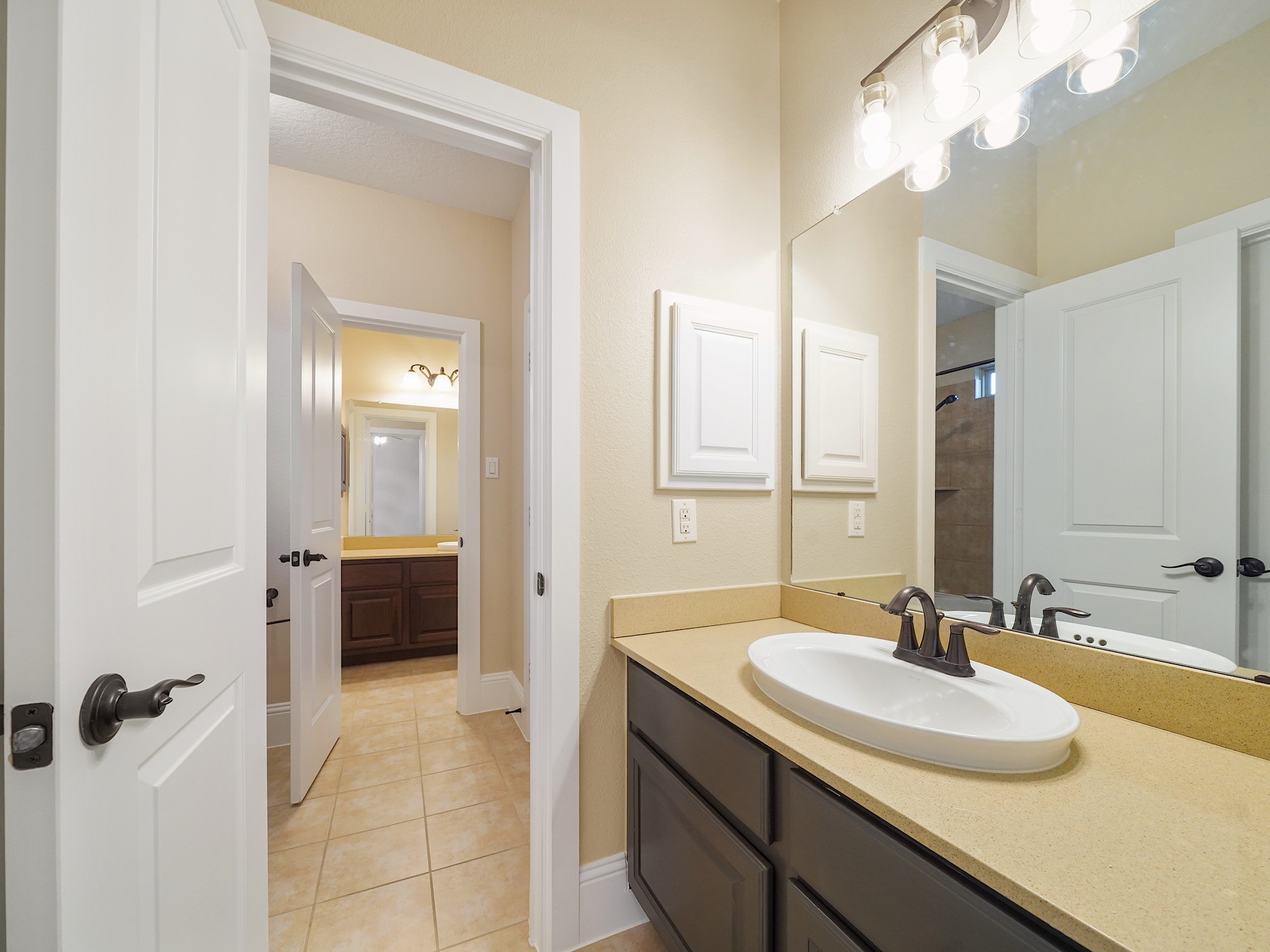 The shared Jack-and-Jill bath balances function and privacy with an efficient layout between the adjoining bedrooms.