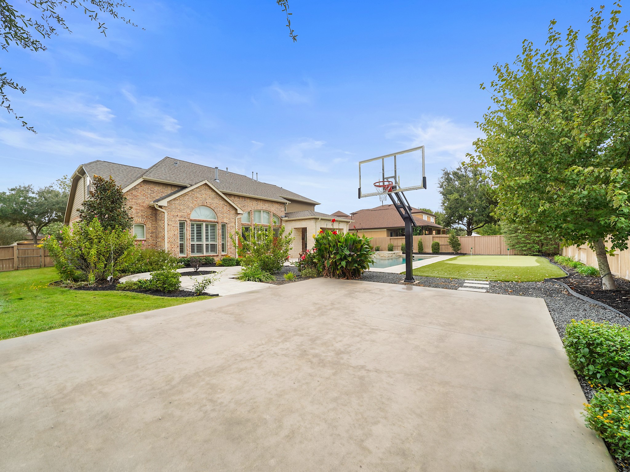 A dedicated sport court with a basketball goal puts another layer of recreation right at home.